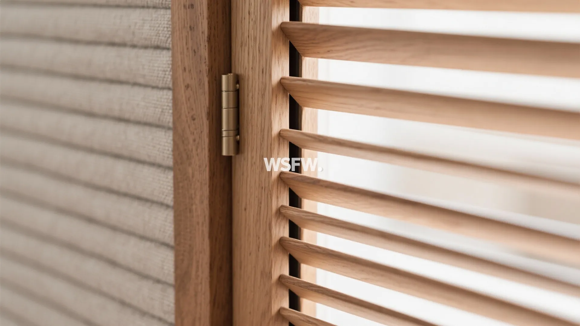 Close up of wooden window shutters with metal hinge and white textured wall in background