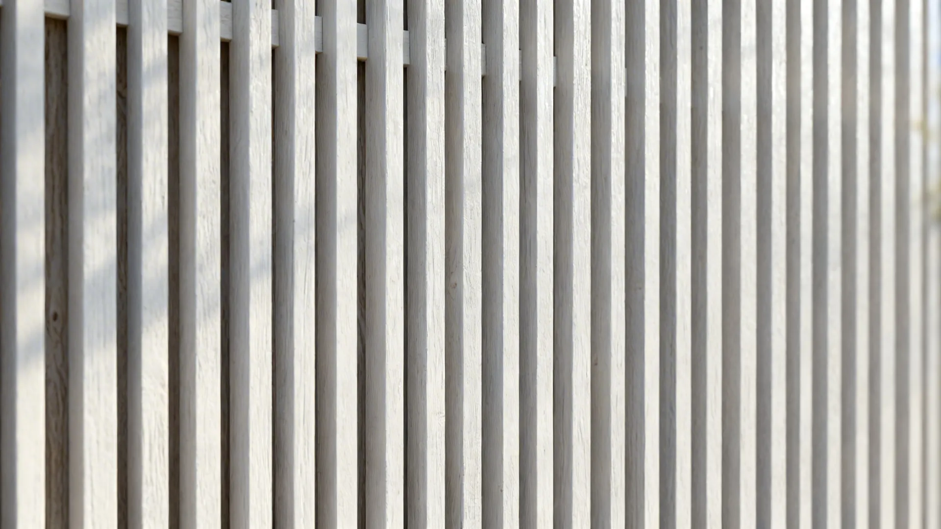 White vertical wood slats arranged in a row creating a clean modern decorative wall panel
