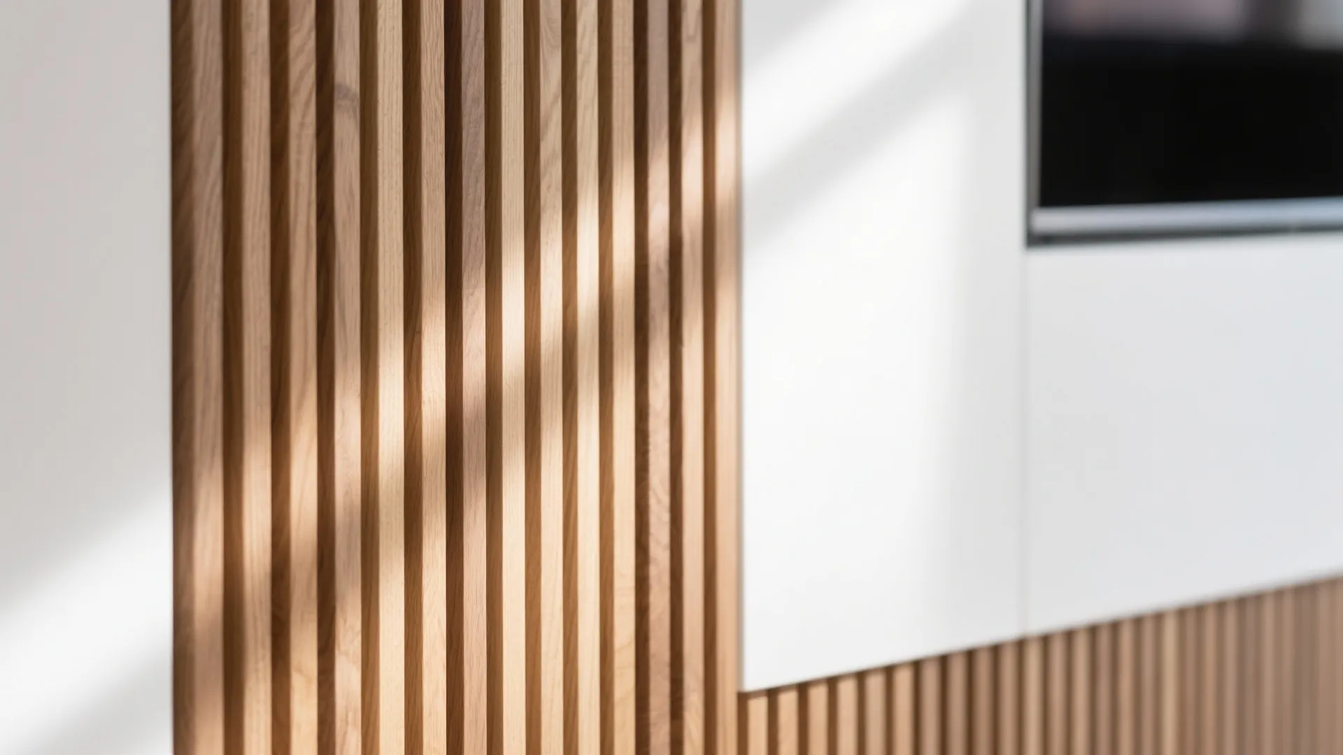 Vertical wooden wall panels with sunlight shadows beside a white wall and black television screen