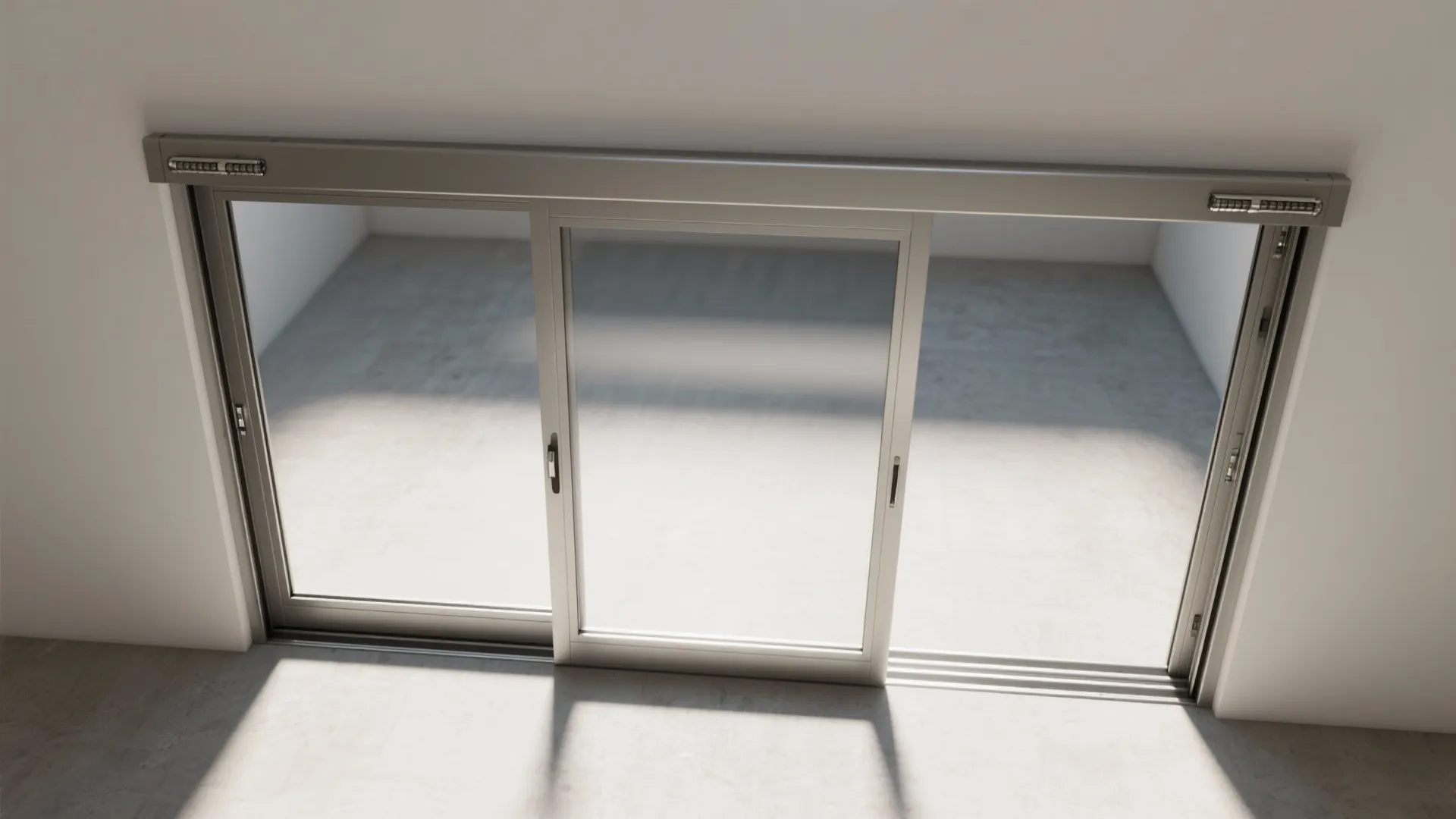 Top down view of silver sliding glass doors in bright room with sunlight on floor