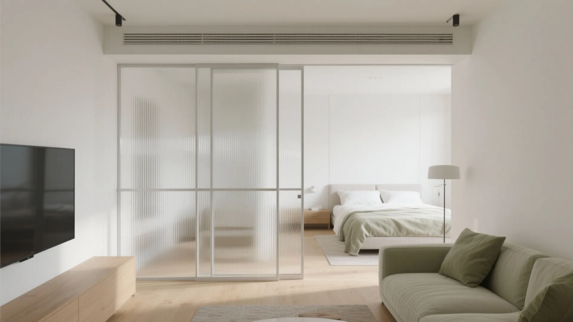 Modern living room featuring green sofa, wooden cabinet, and glass sliding door partition for bedroom space