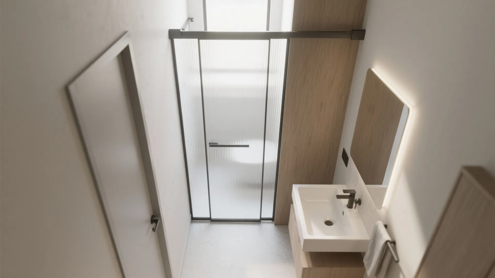 Small bathroom view with sliding frosted glass door black frame wood wall and white sink