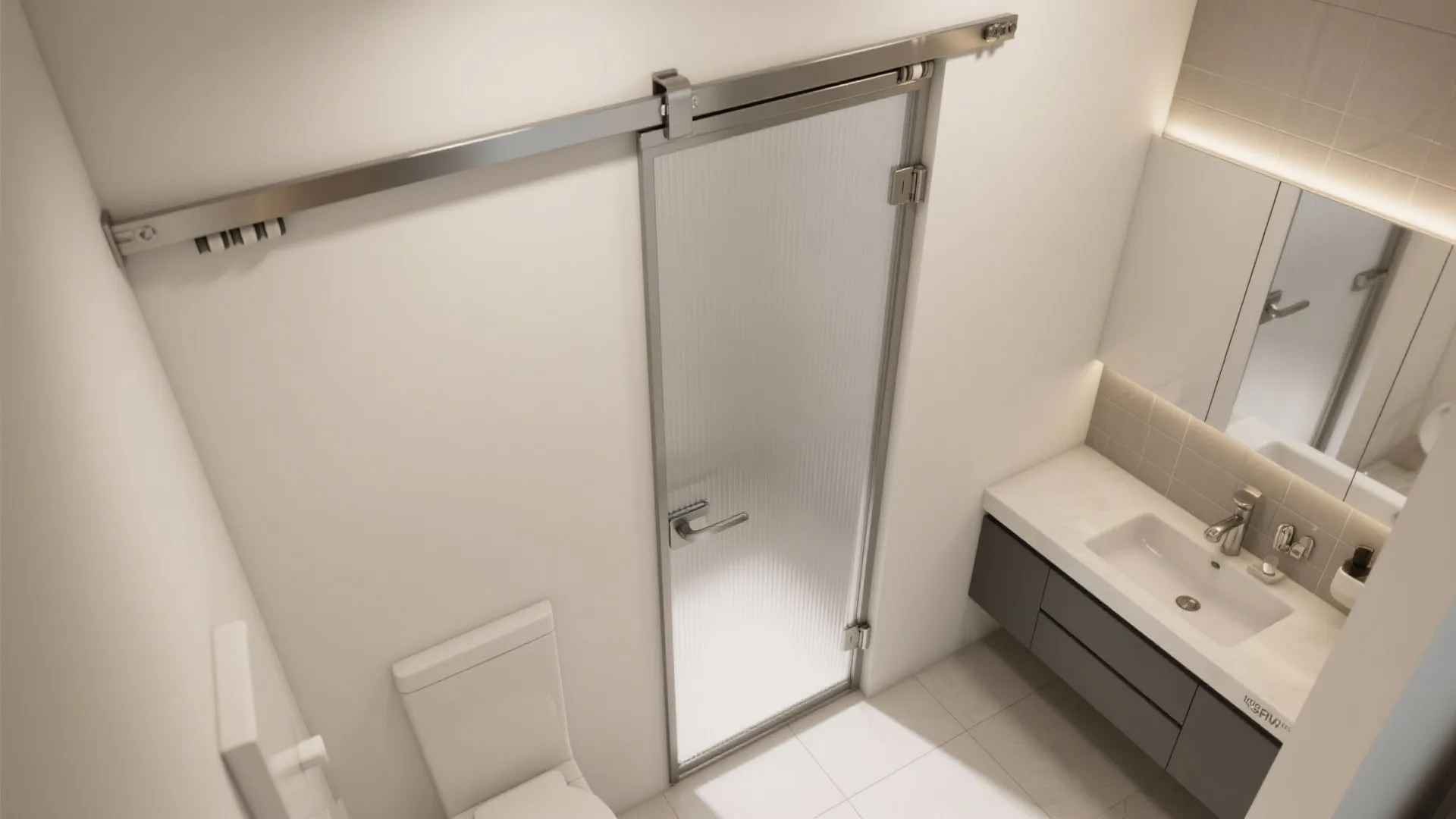 Top down view of a glass sliding door in a bathroom with white sink cabinet
