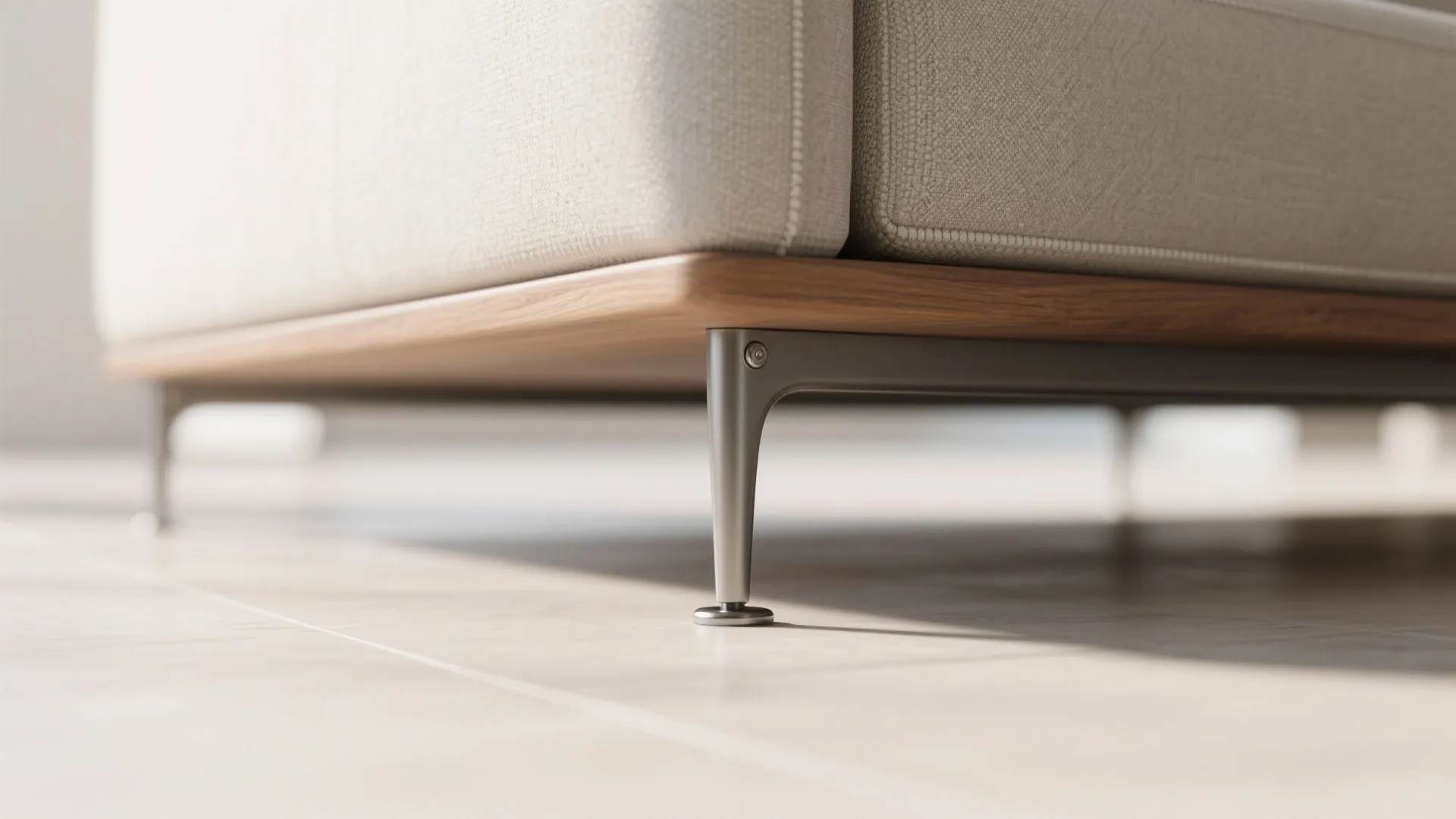 Close up view of sofa with thin metal legs and light wood base on floor