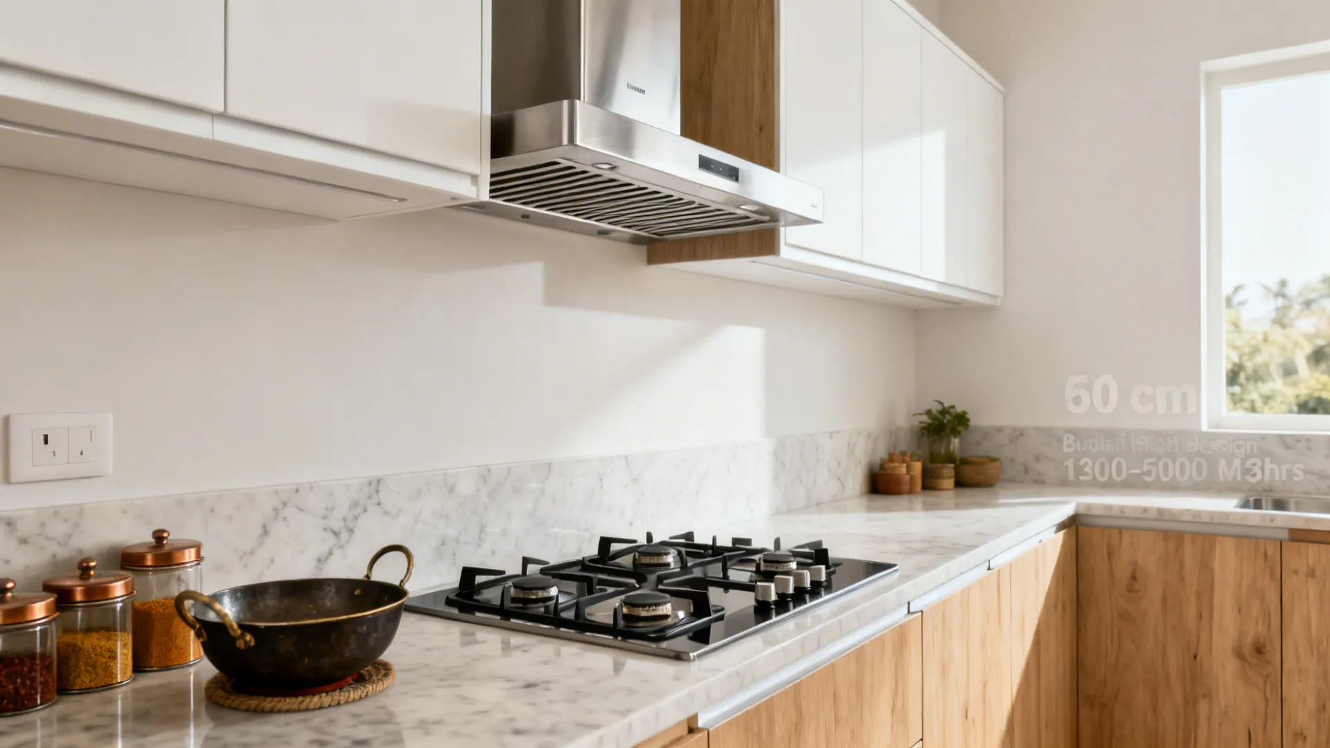 Slim stainless-steel wall-mount chimney with baffle filters above a 60 cm hob in a compact Indian galley kitchen.