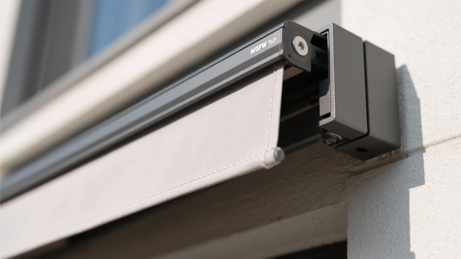 Detailed view of grey metal window curtain box mounted on exterior wall showing slim design parts