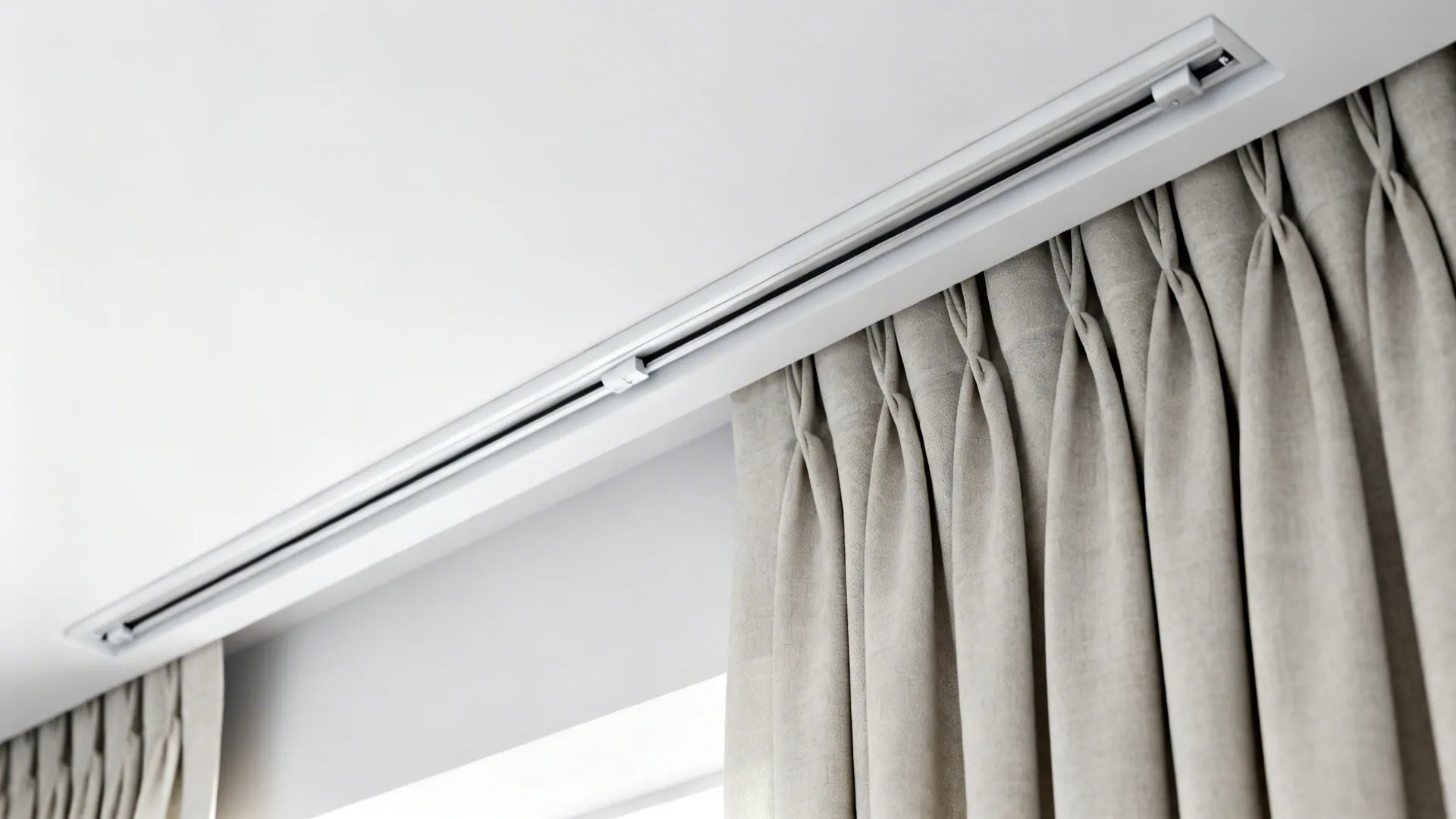 Slim recessed curtain track mounted close to the ceiling with neatly gathered panel