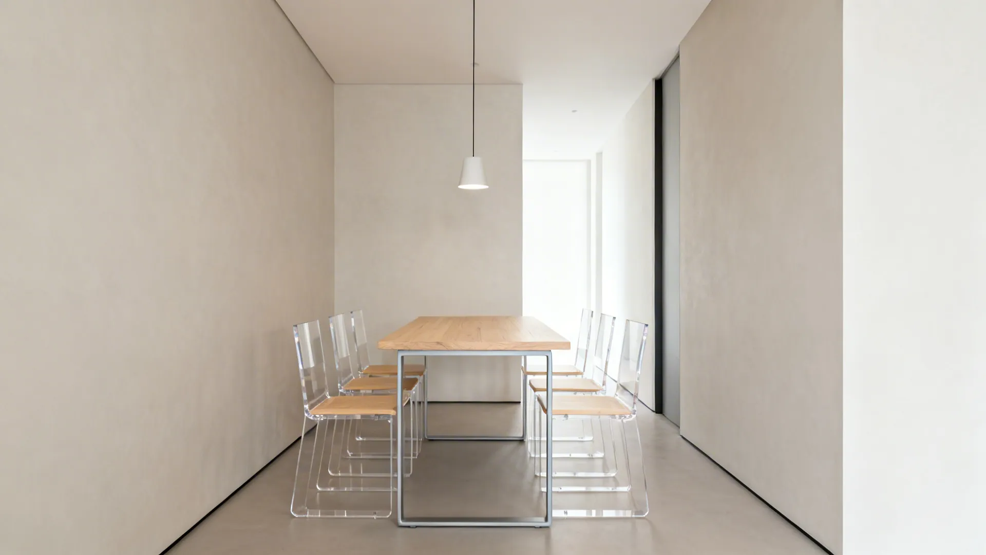 Narrow dining alcove with a compact table and slim, open-back chairs for better circulation.