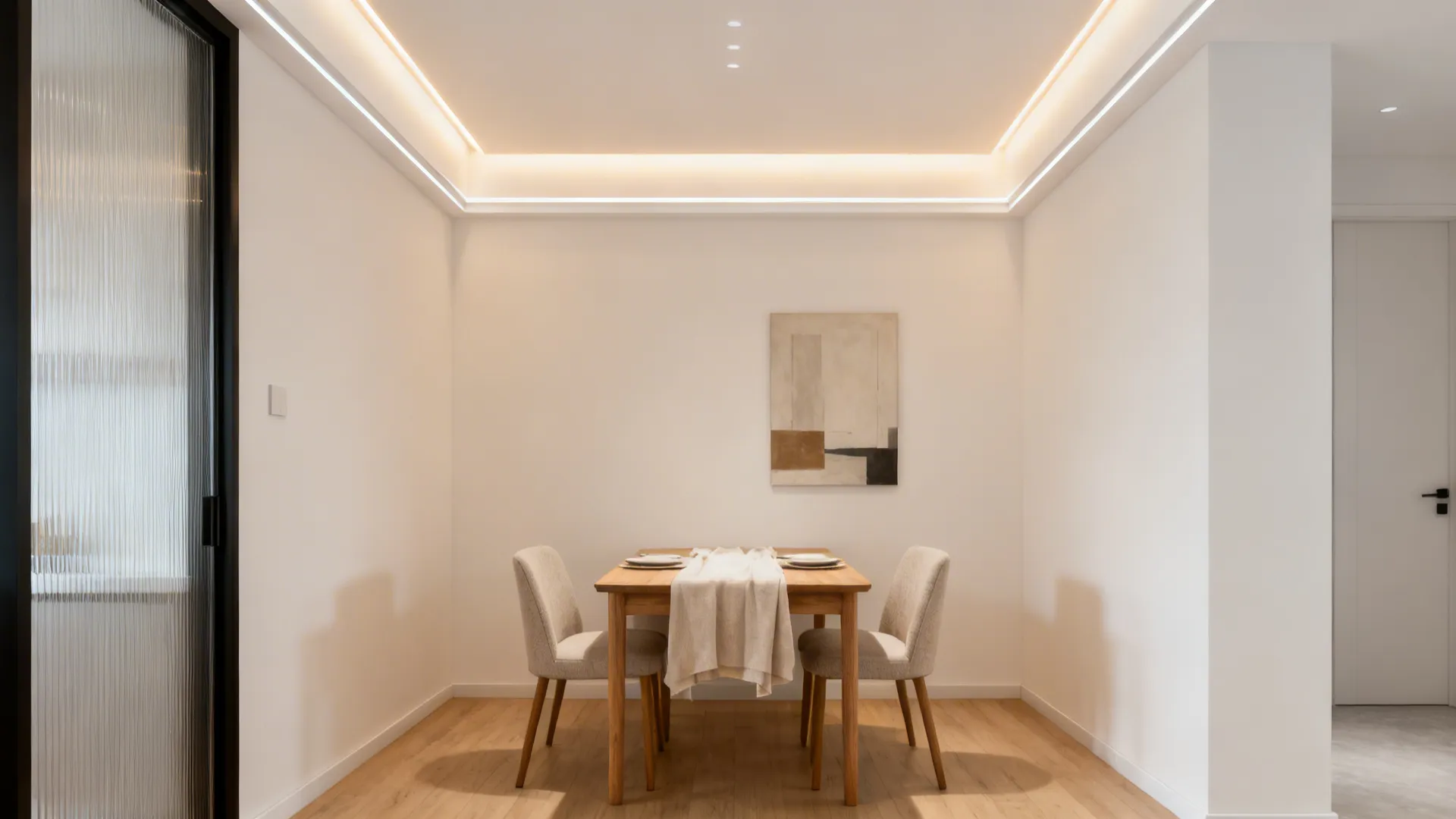 Small dining room with a slim perimeter cove ceiling casting a warm halo.