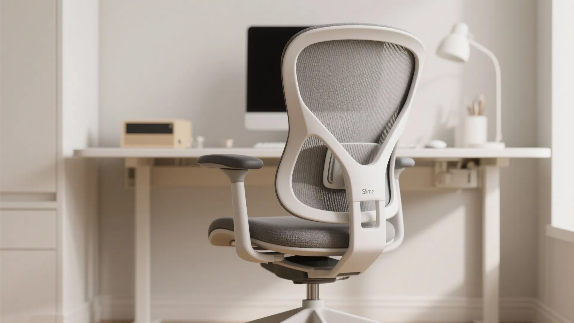 White ergonomic mesh office chair standing in front of a minimalist white desk with a computer