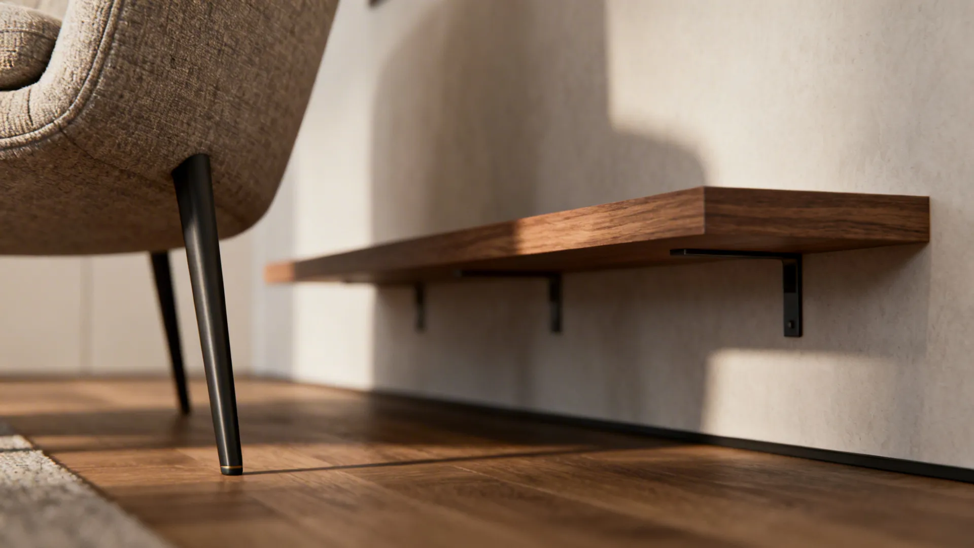 Close-up of slim armchair leg and low-profile sofa base illustrating scaled furniture