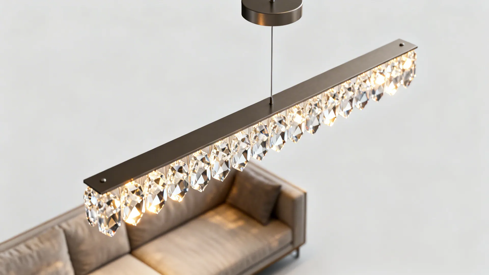 Macro view of a slim linear crystal bar pendant with faceted crystals and matte metal finish.