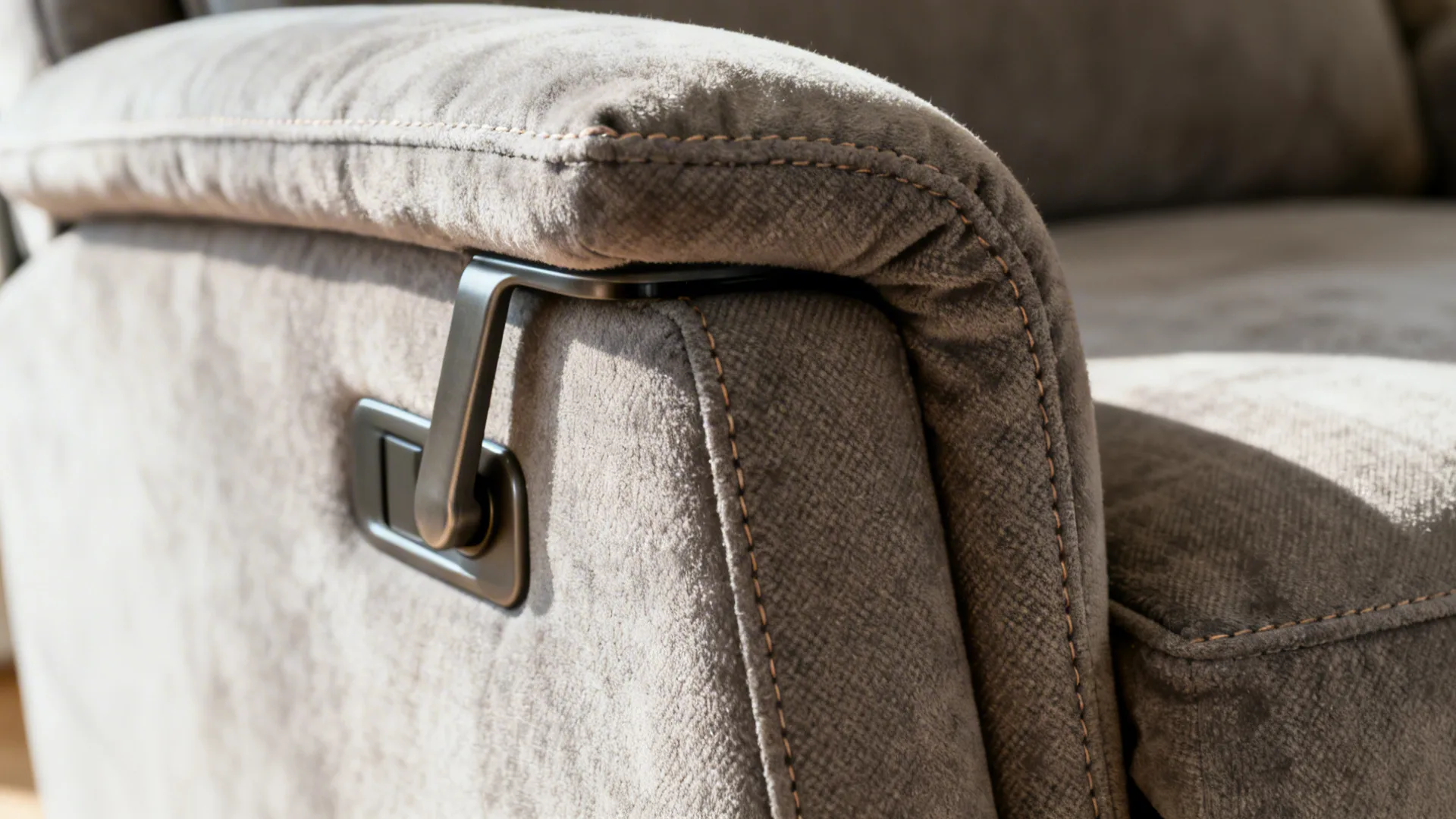 Macro detail of a slim-profile recliner showing microfiber fabric and manual lever.