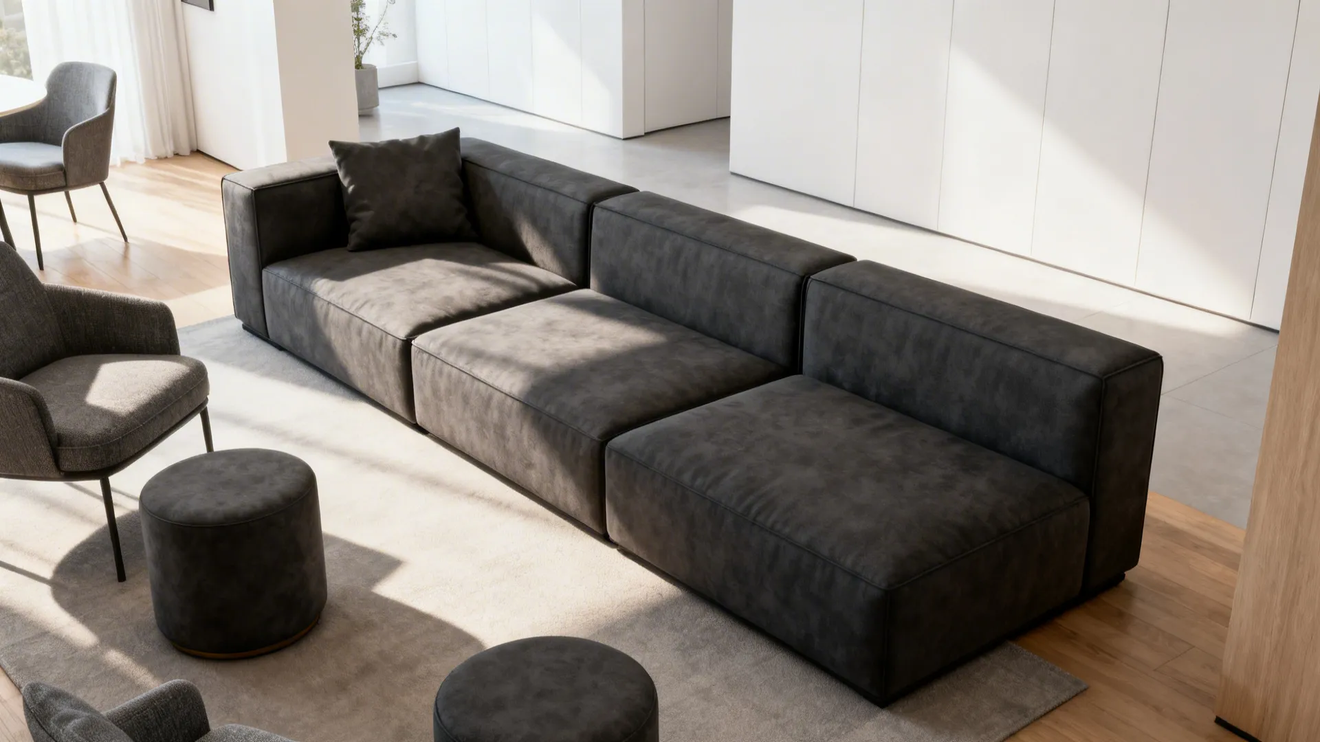 Modern living room with long grey sofa two grey chairs and two round grey footrests