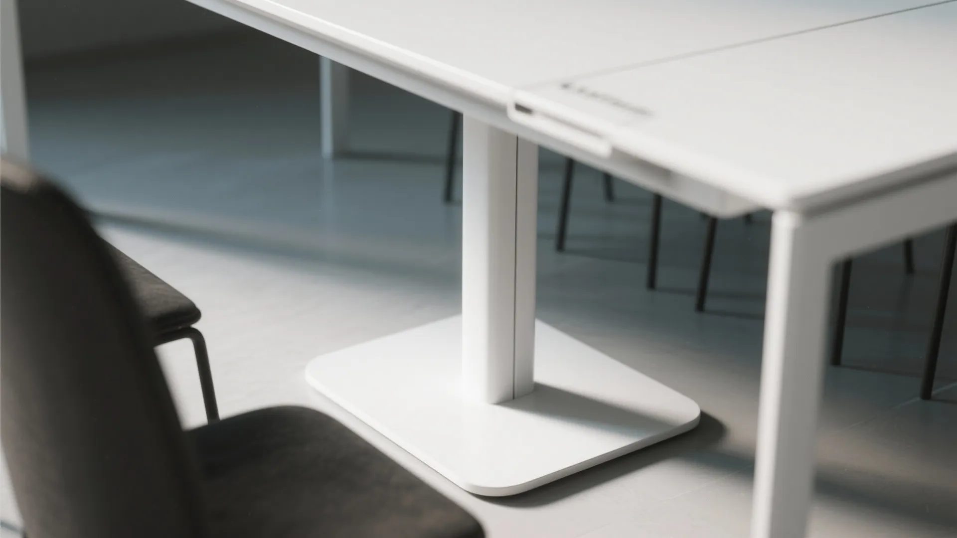 Close up view of a white table base support and minimalist white table top room