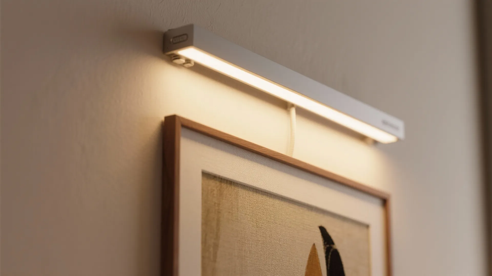 Modern white wall light illuminating a framed painting with warm glow in a simple room