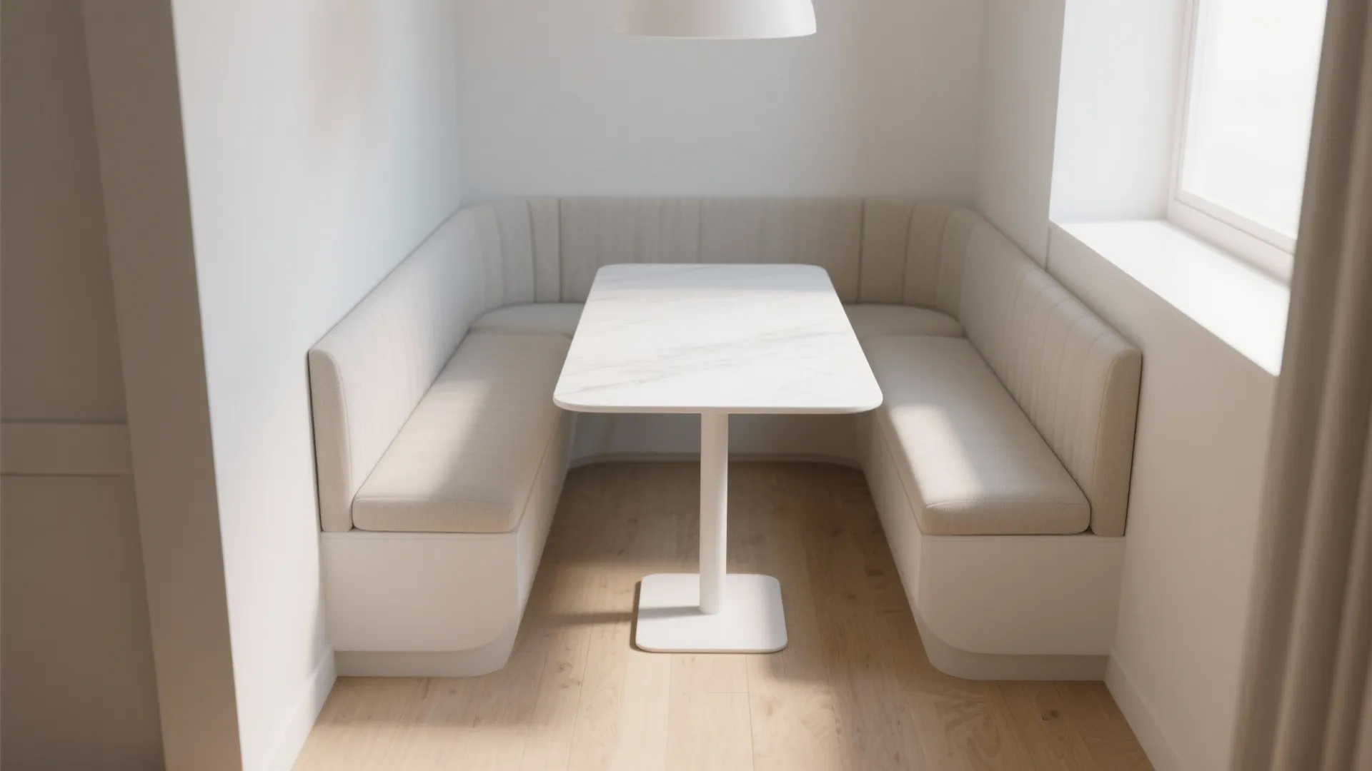 Narrow white rectangular dining table with a cushioned bench tucked underneath in a compact nook.