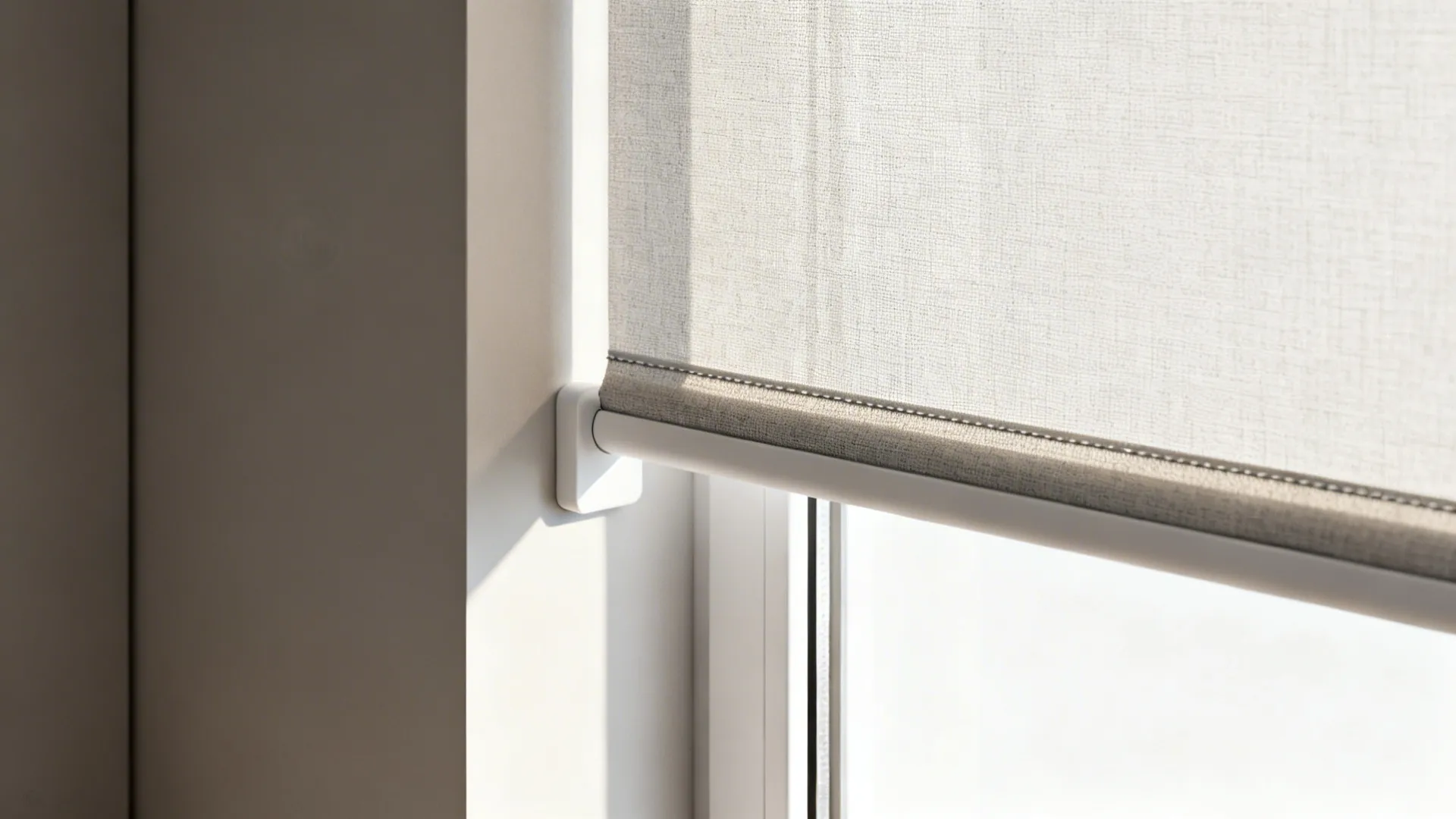 Close-up of slim roller blind fabric and narrow pelmet in a small living room.