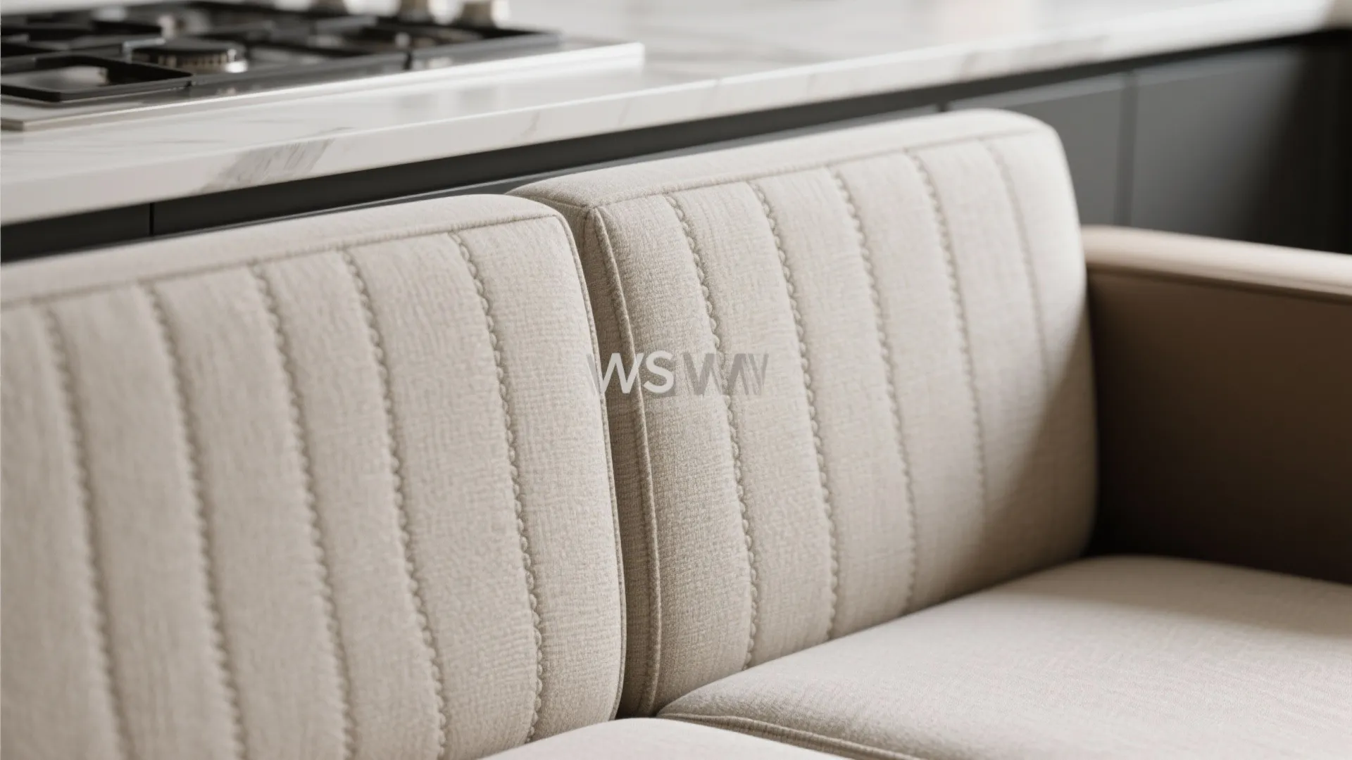 Close up view of beige fabric sofa with vertical stitched patterns in a modern kitchen