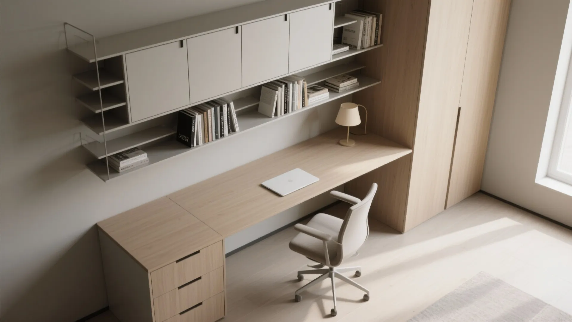 Minimalist home office with wooden desk, white chair, overhead wall cabinets, books, and large wardrobe
