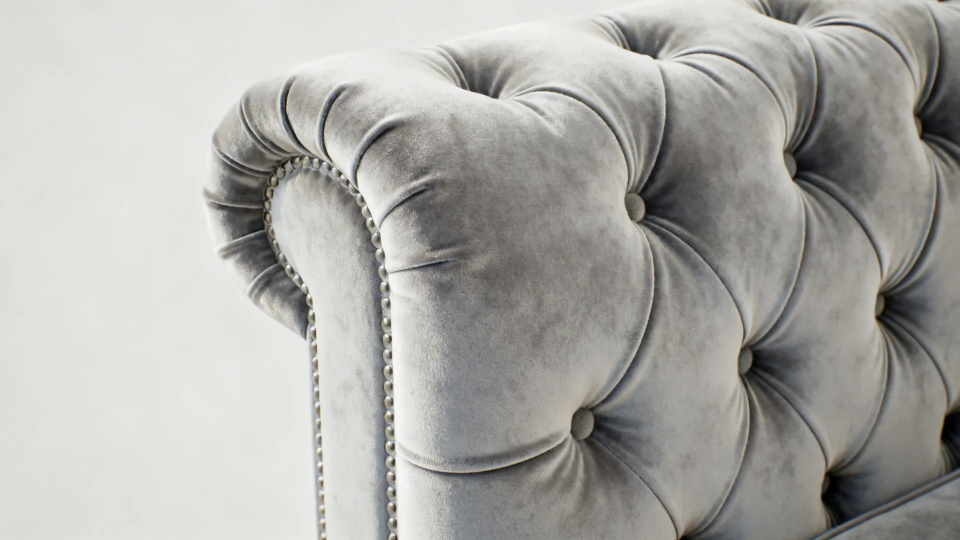 Macro view of slimline pale gray Chesterfield tufting and performance velvet texture.
