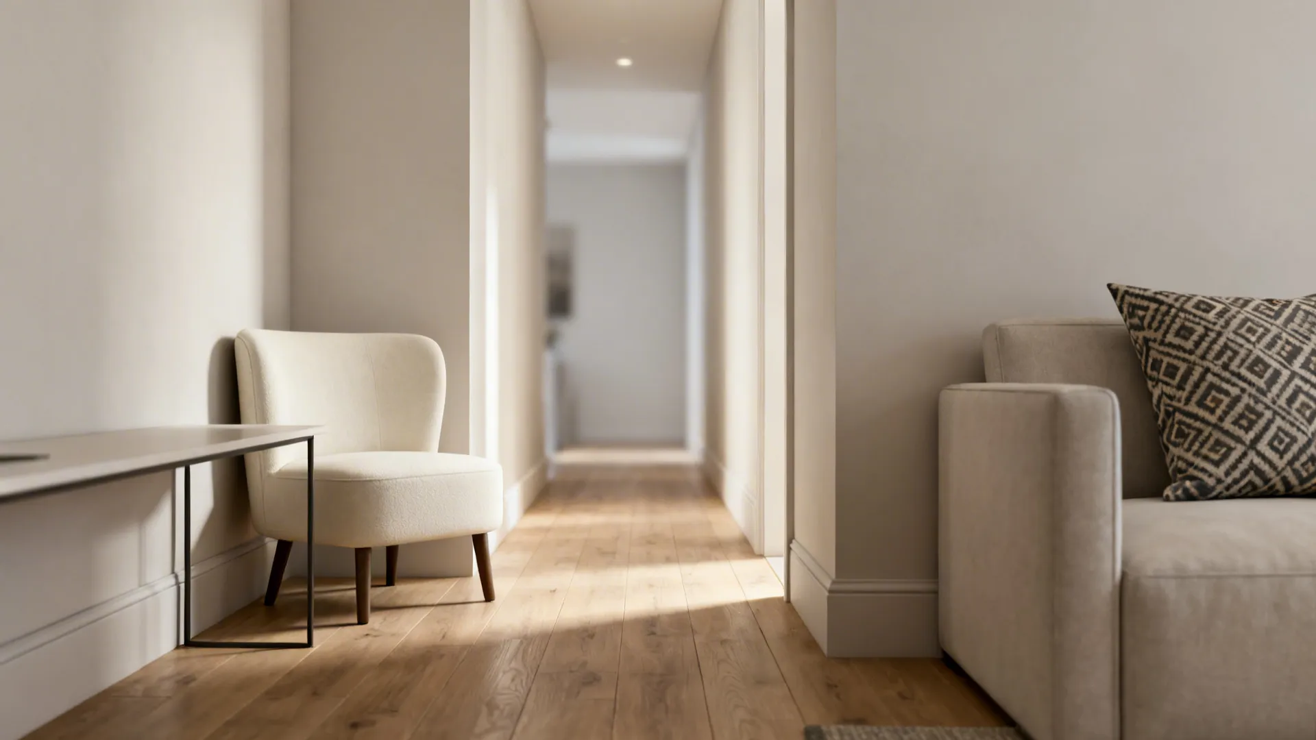 Armless cream slipper chair beside a slim console in a narrow living room
