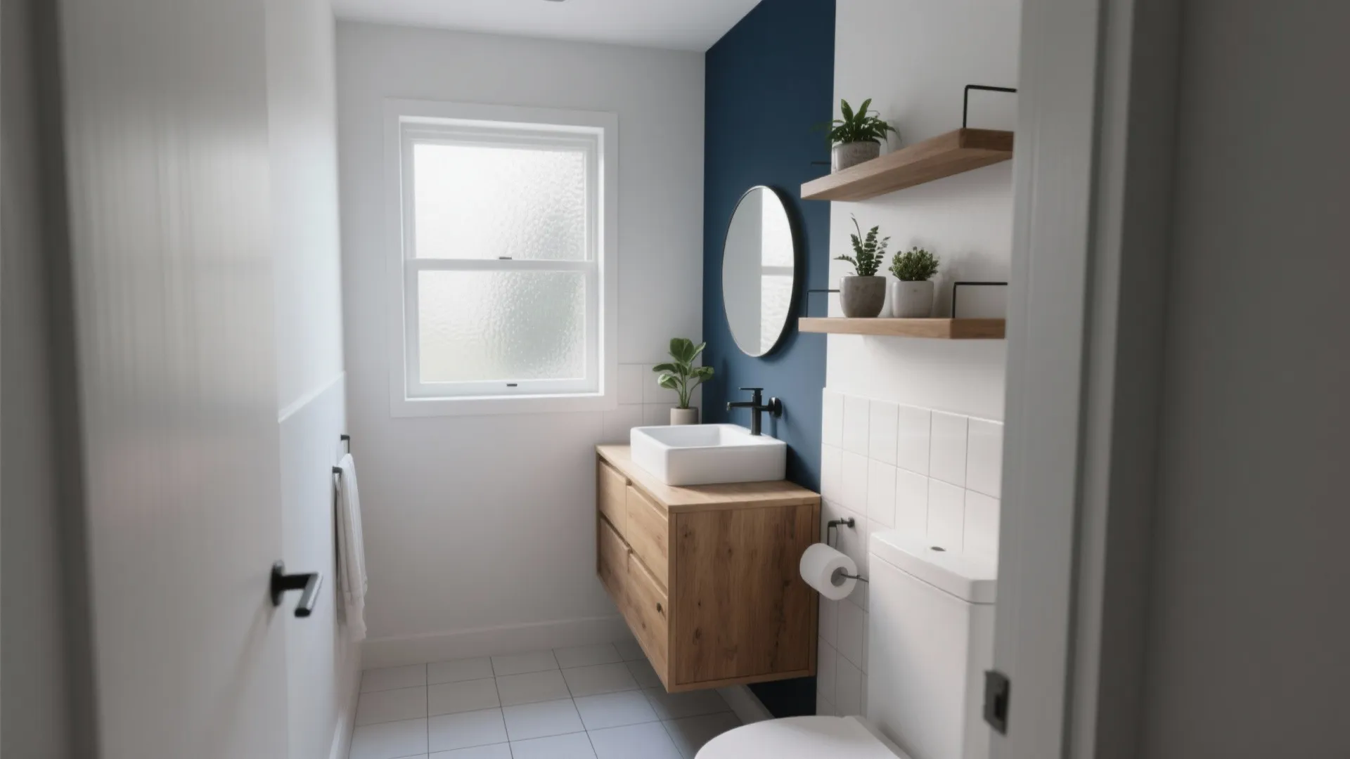 Small modern bathroom with blue wall, wooden cabinet, round mirror, floating shelves, and white toilet