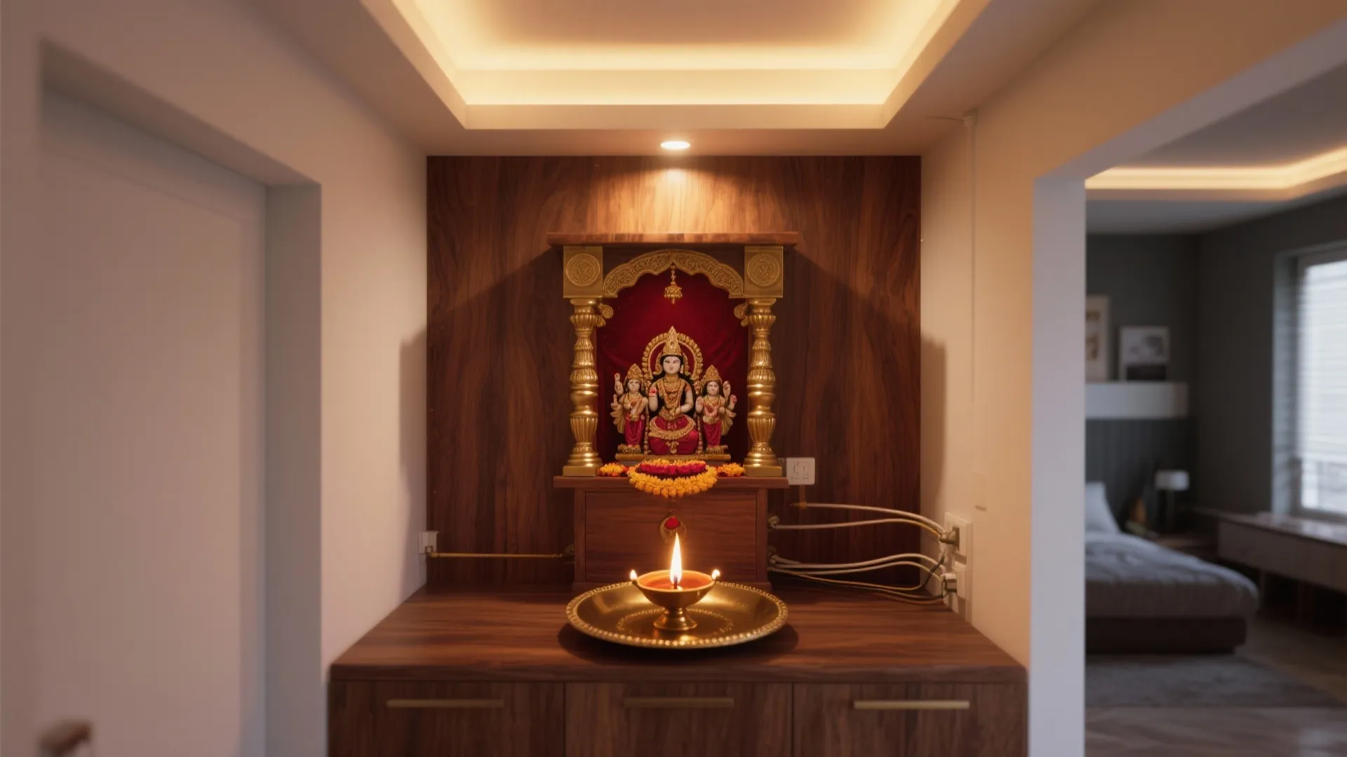 Small home altar on wood cabinet with gold statue warm ceiling light and oil lamp