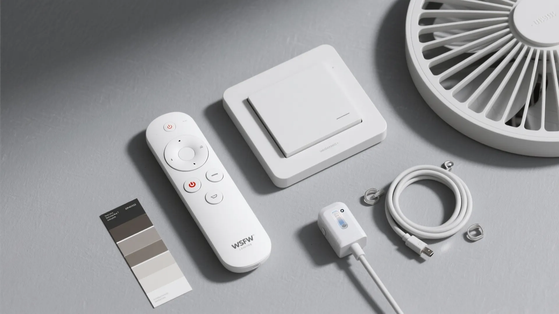 Flat lay of smart fan accessories with neutral material swatches on a gray surface.