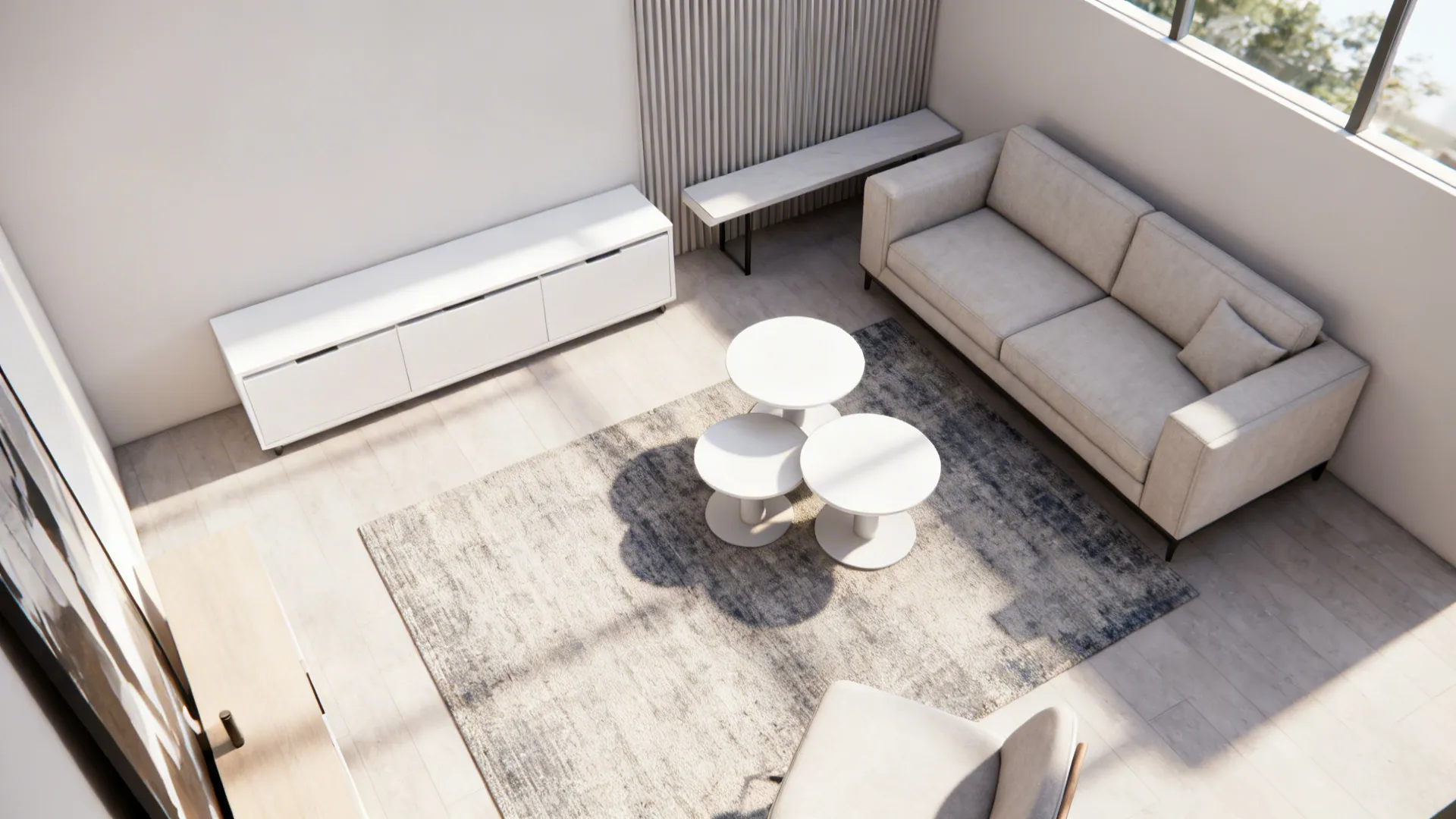 Top-down view of bright living room with beige sofa white cabinet and round coffee tables