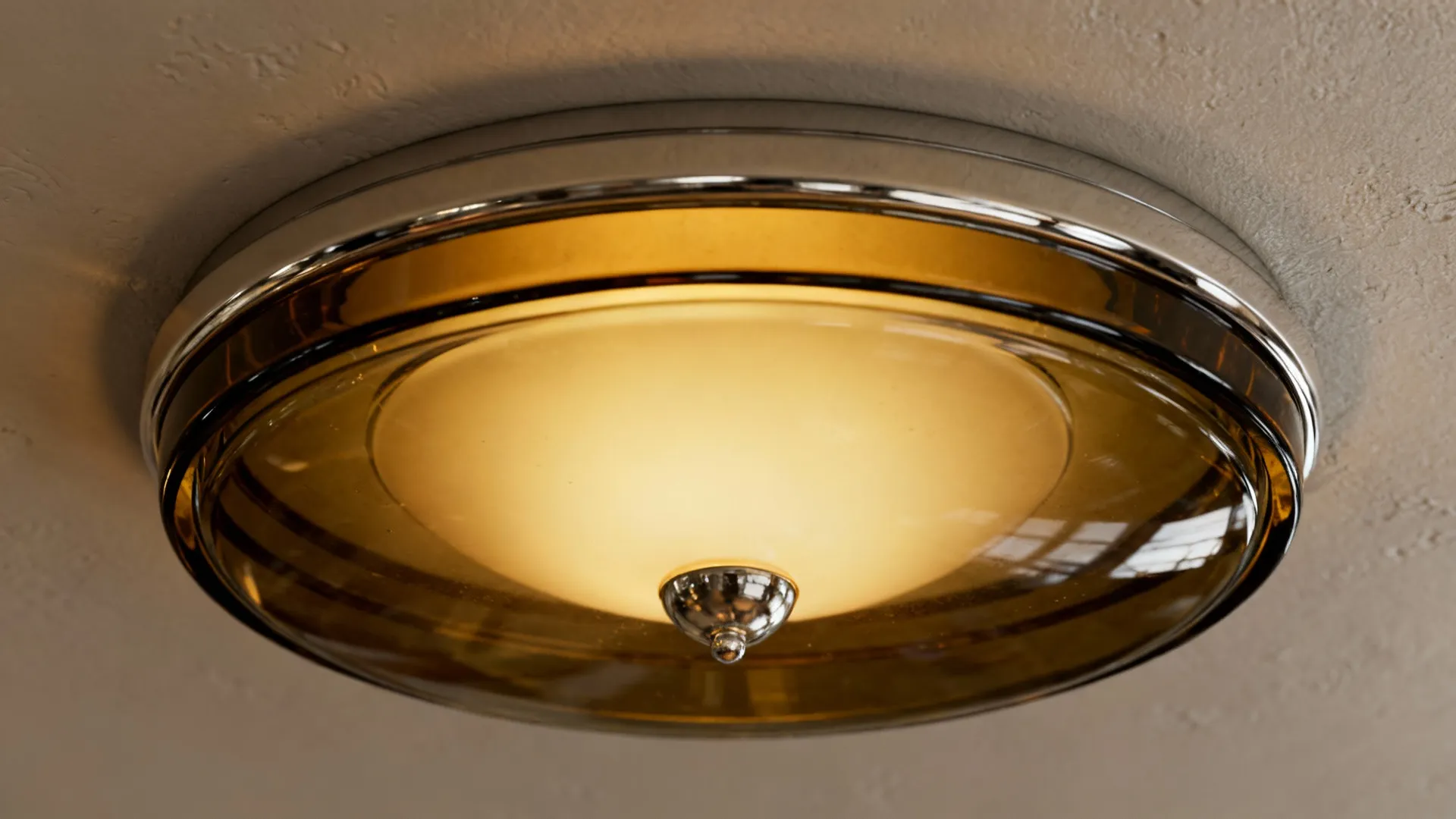 Shallow smoked-glass flush-mount fixture close-up preserving headroom in a low-ceiling living room