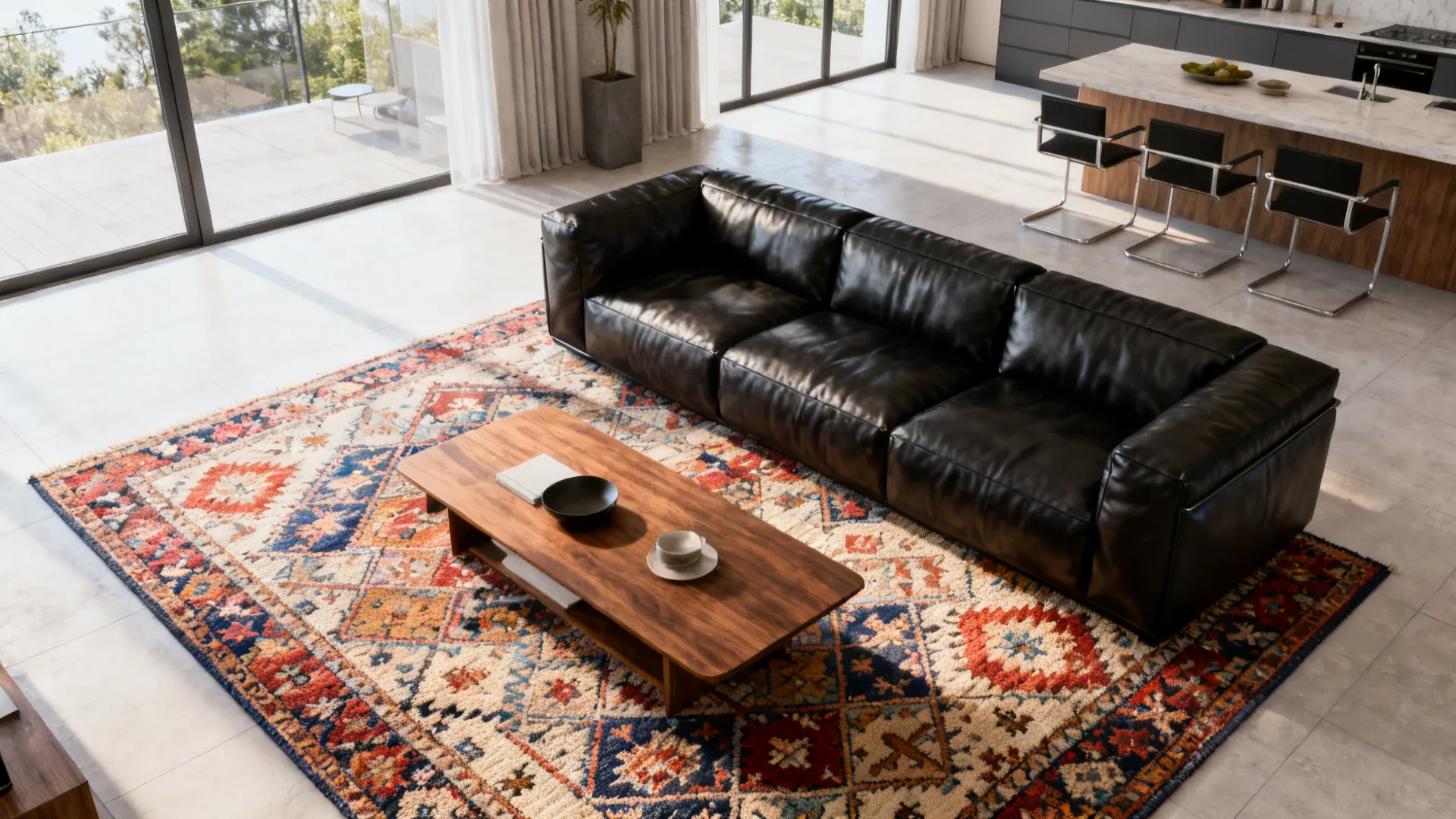 Black leather sofa set on a patterned rug that defines the seating area in an open-plan living room.