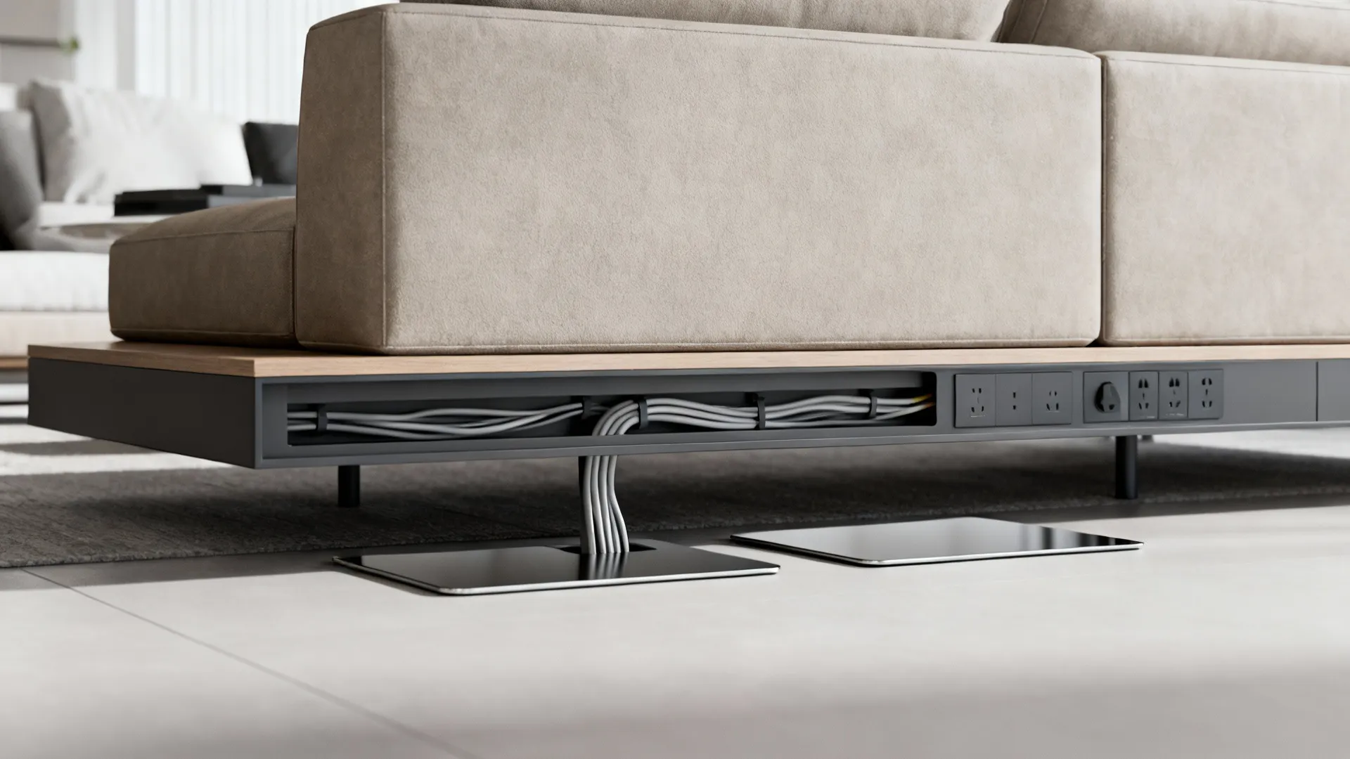 Slim console behind a sofa with hidden wiring channels and a floor power outlet solution.