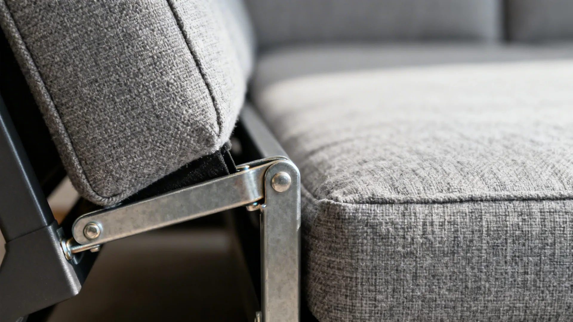 Close-up of a sturdy sofa-bed hinge and durable woven upholstery.