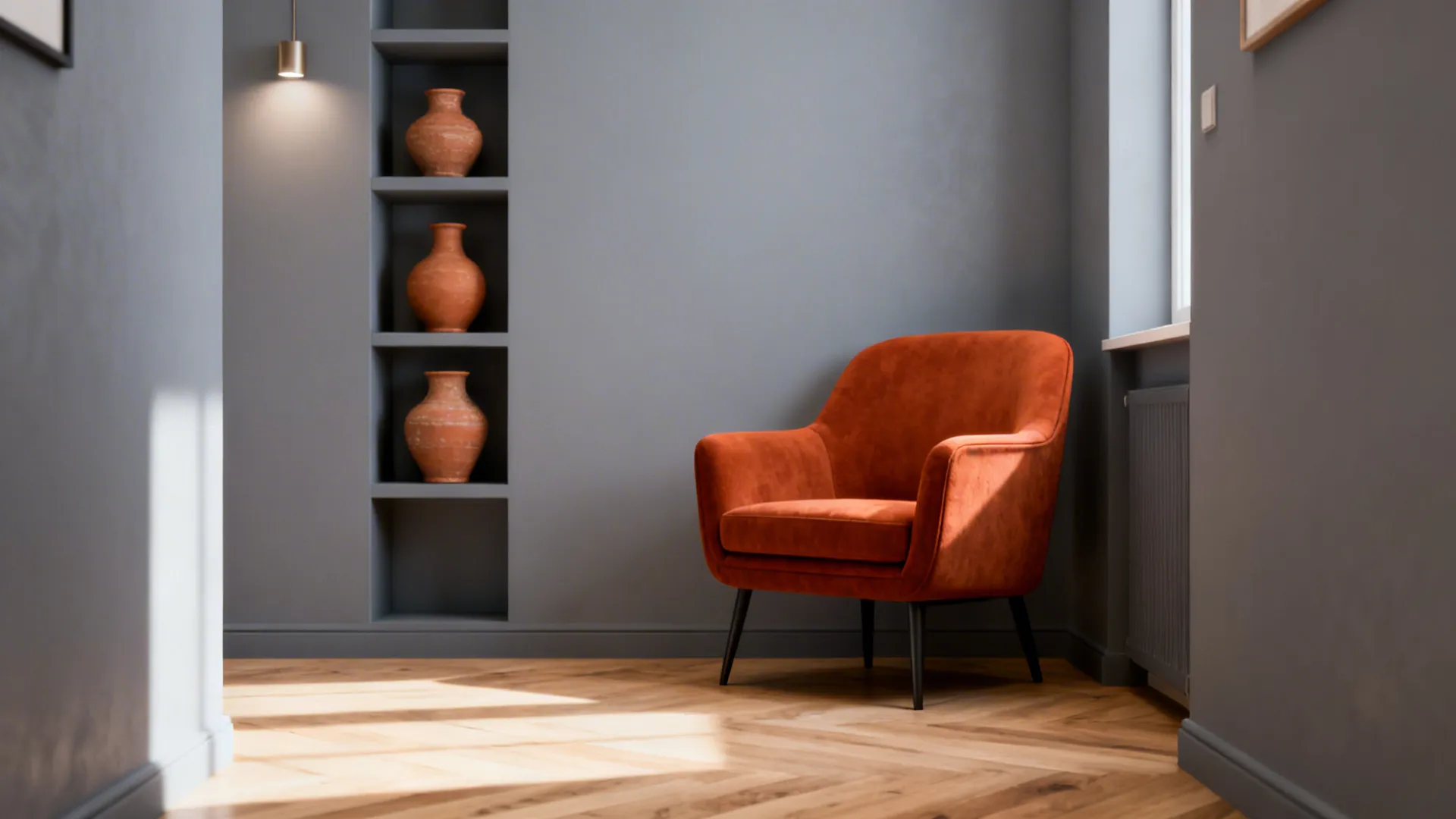 Compact living area with soft grey walls and a single burnt-orange armchair beside terracotta vases.