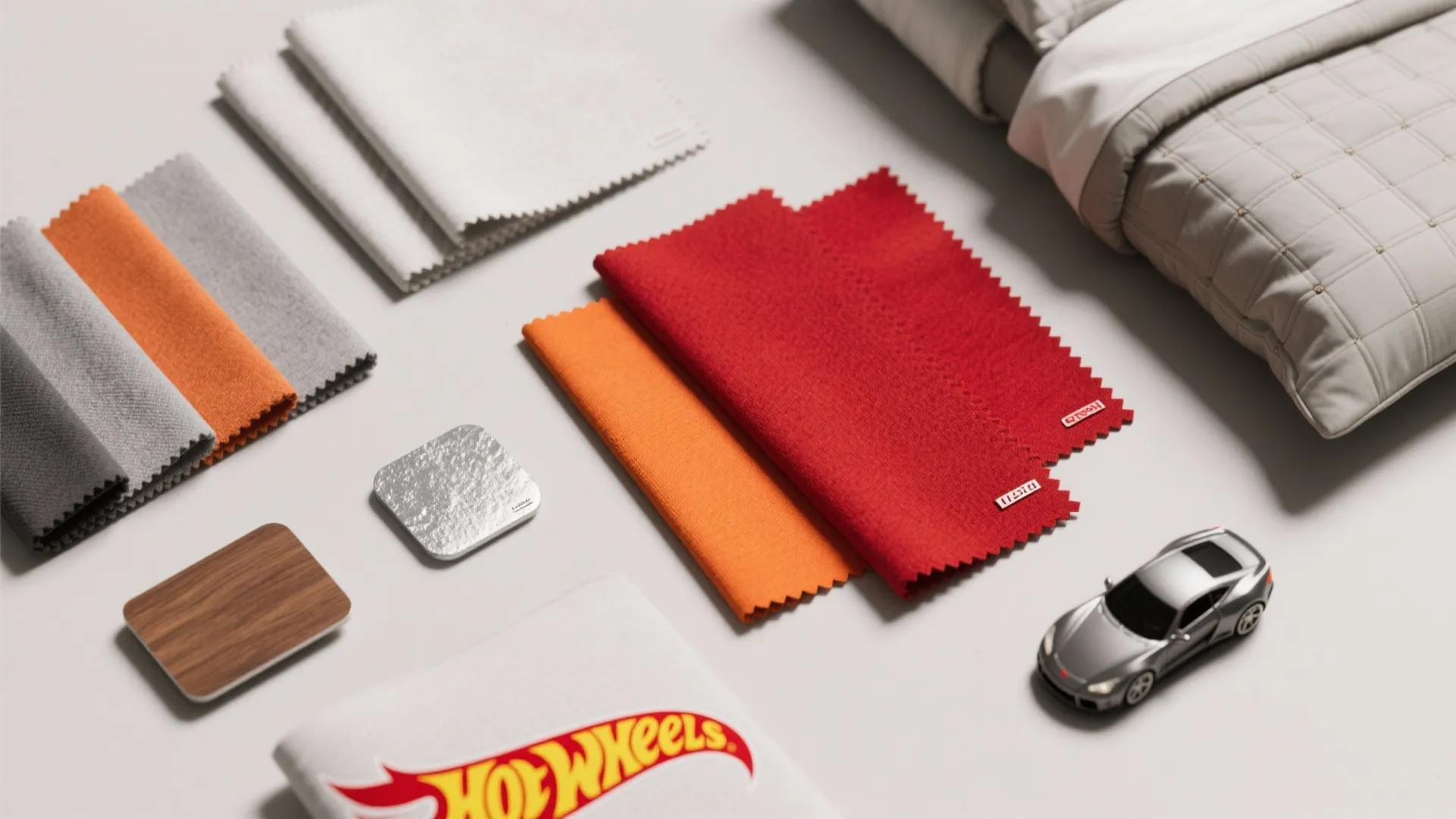 Interior design material board with fabric swatches wood samples and a silver toy race car