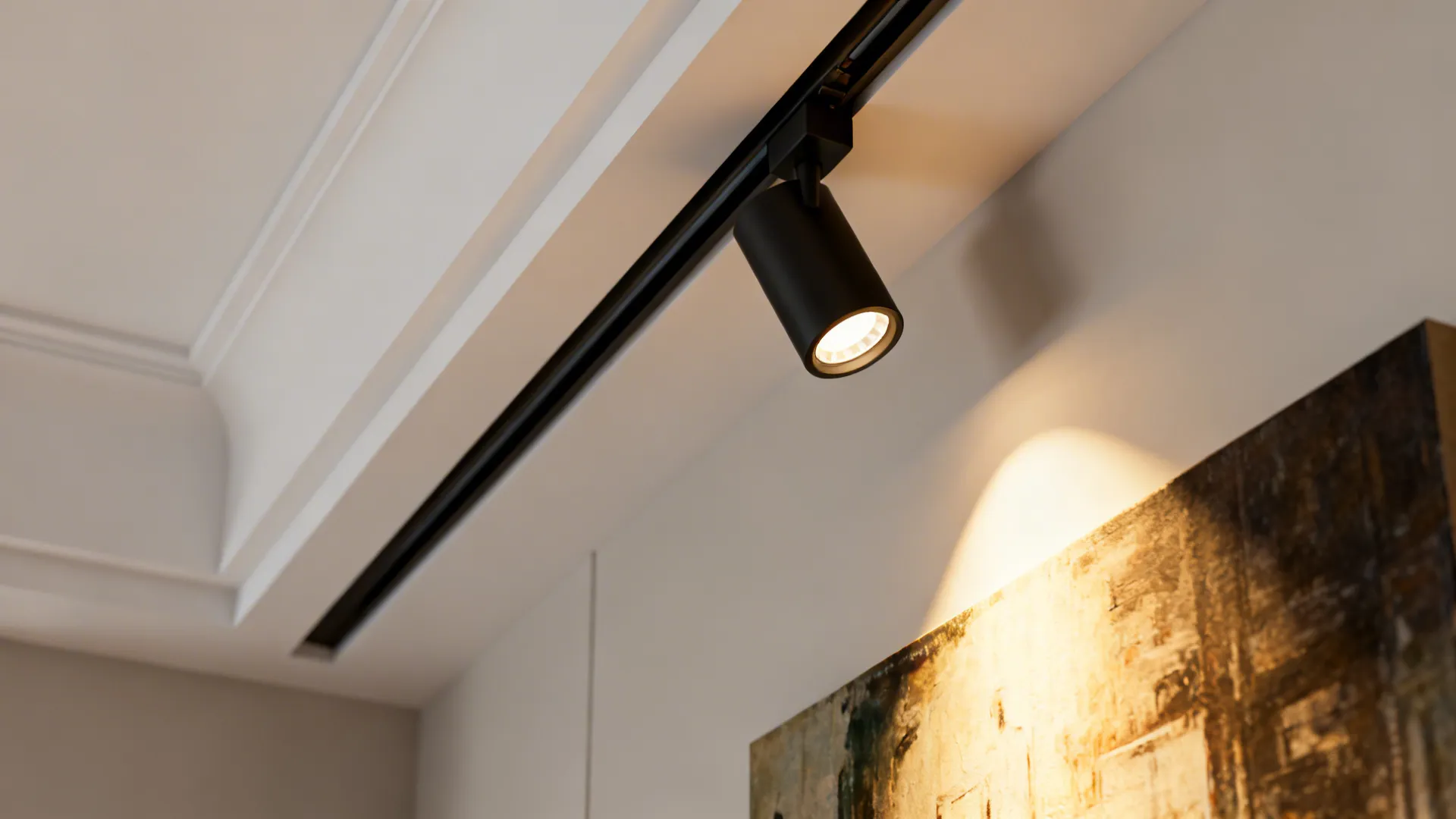 Black track light fixture on white ceiling illuminating an abstract wall painting in a modern room
