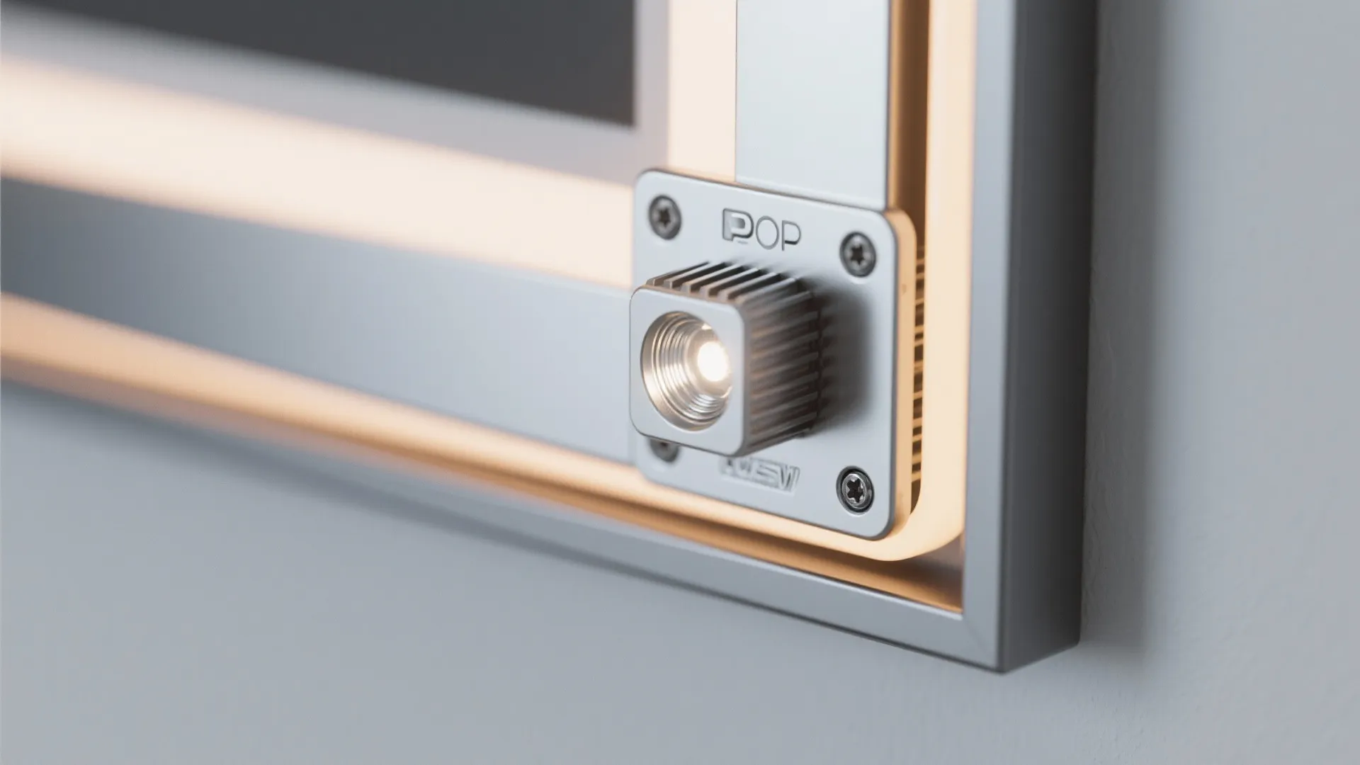 Close up of small light fixture attached to a metal frame with warm glowing lines