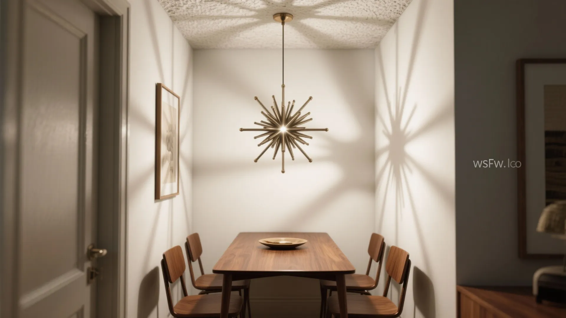 Small dining nook with wooden table, four chairs, white walls, and star shaped ceiling light
