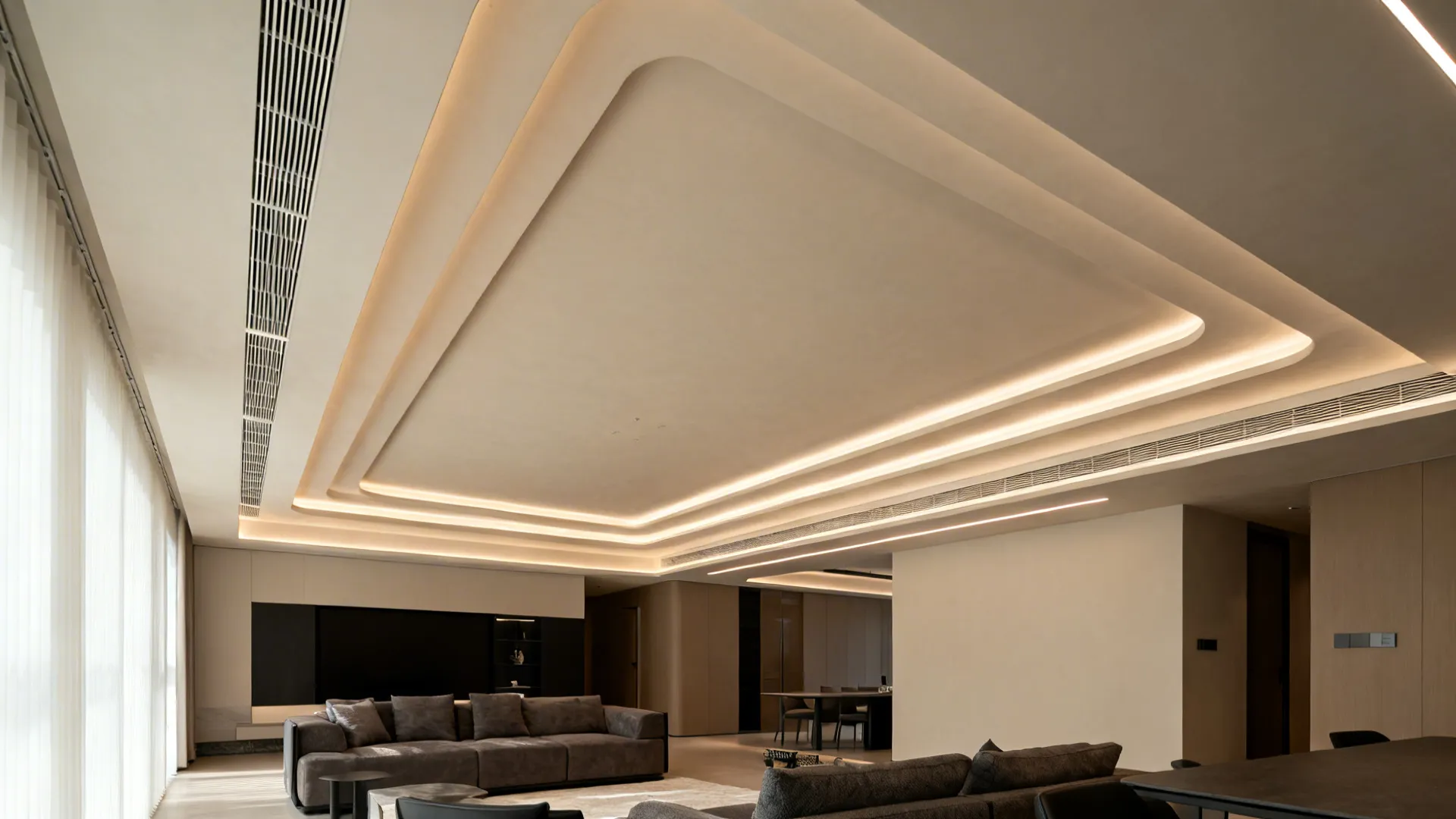 Staggered false ceiling tiers with linear LEDs trace the L-shaped living room layout.