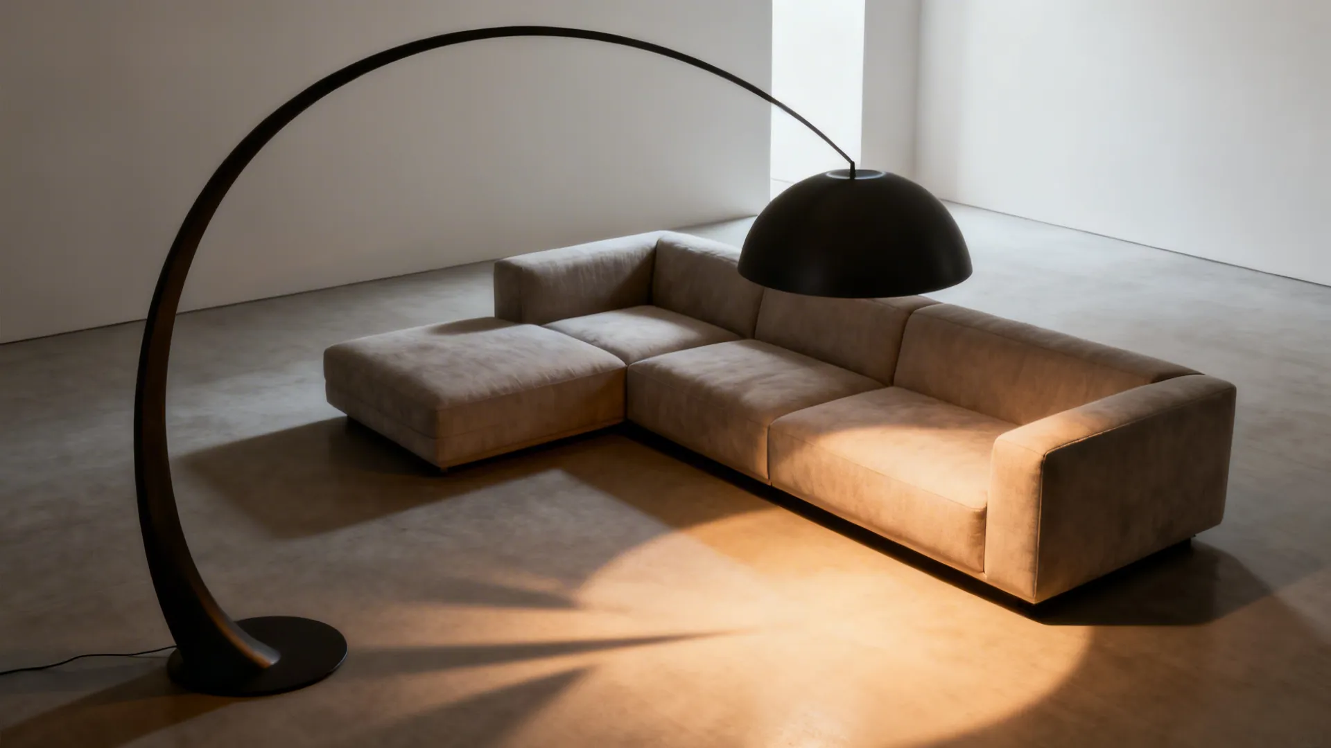Oversized sculptural arc floor lamp casting warm light over a minimalist sectional sofa.