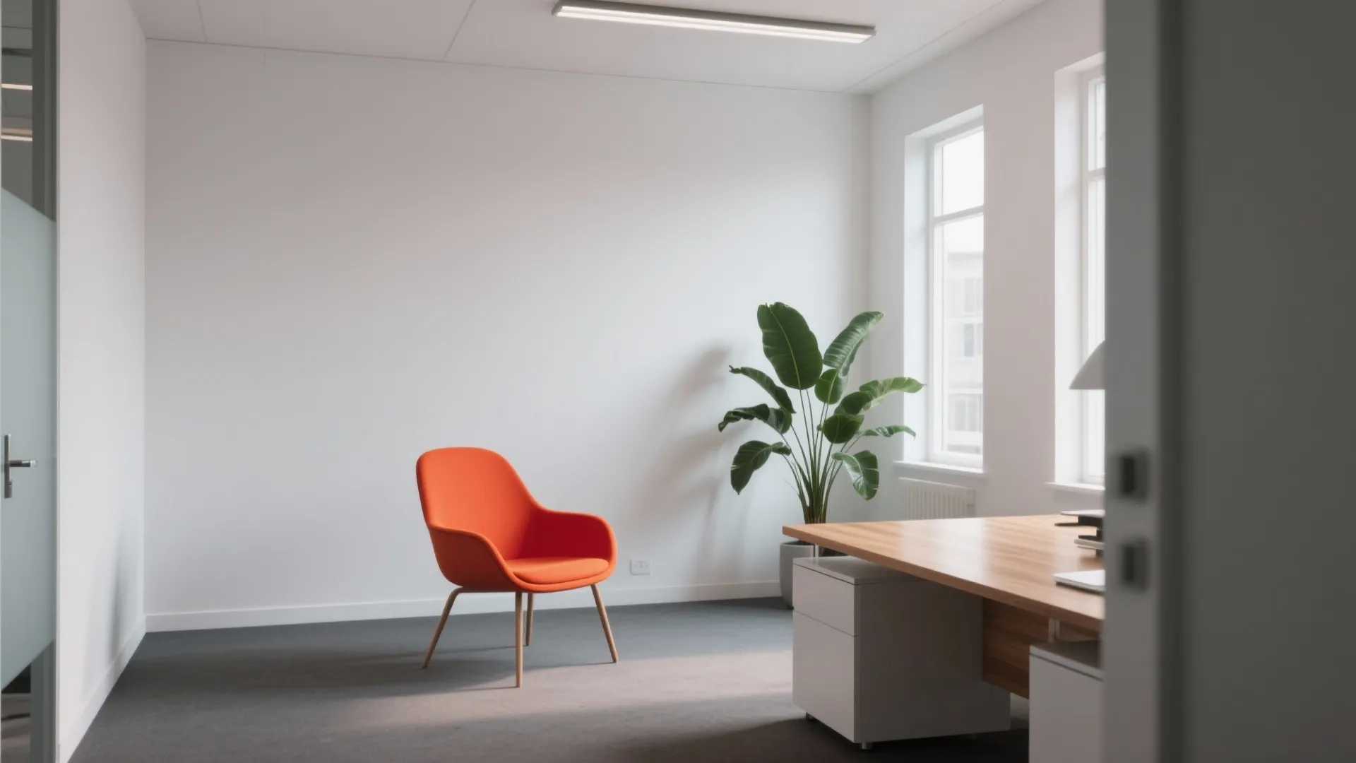 Minimalist office space with one bold designer chair