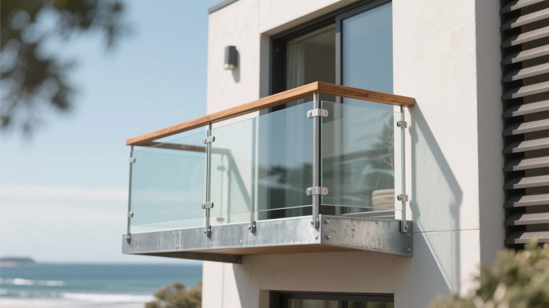 Modern balcony design with glass railing and wooden handrail attached to a white exterior wall