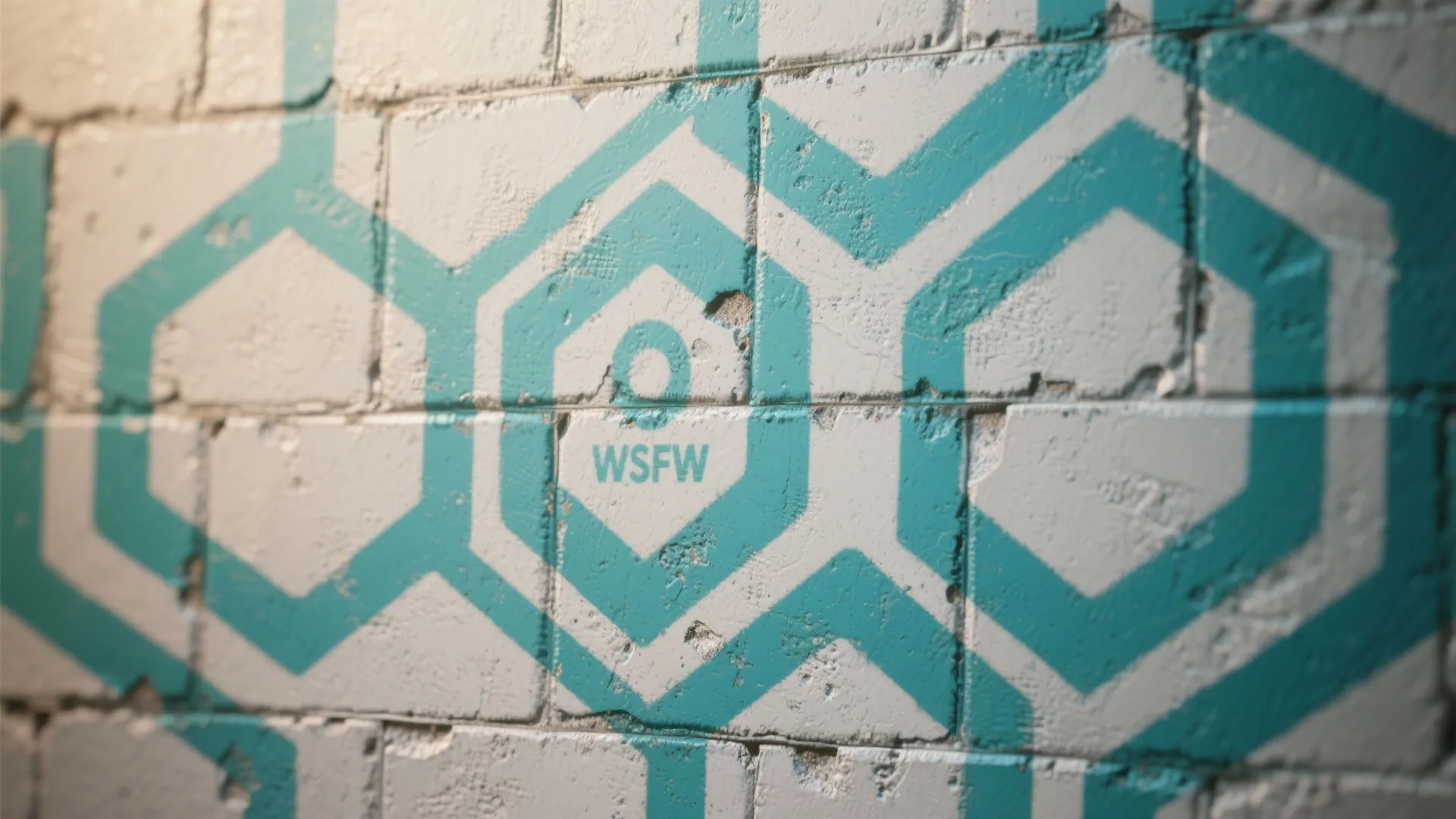 Close up view of white brick wall with blue geometric hexagon shapes painted on surface