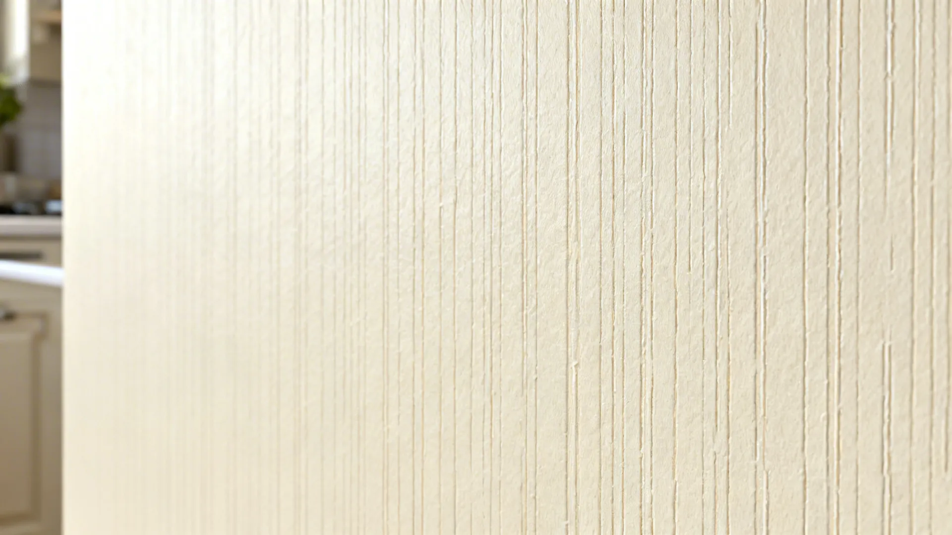 Macro detail of a pale micro-pattern stencil with crisp edges on an ivory wall.