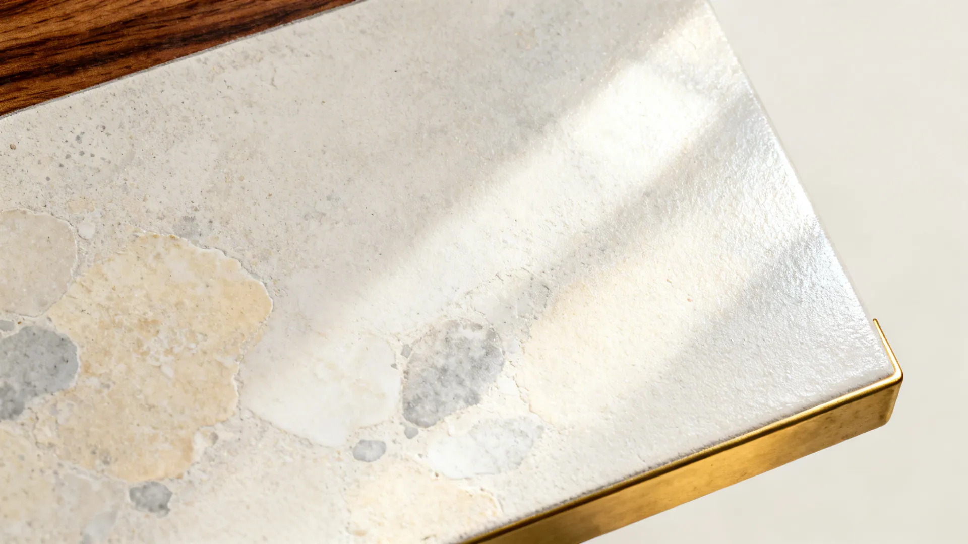 Macro of pale microcement wall with subtle mineral variation and satin topcoat.