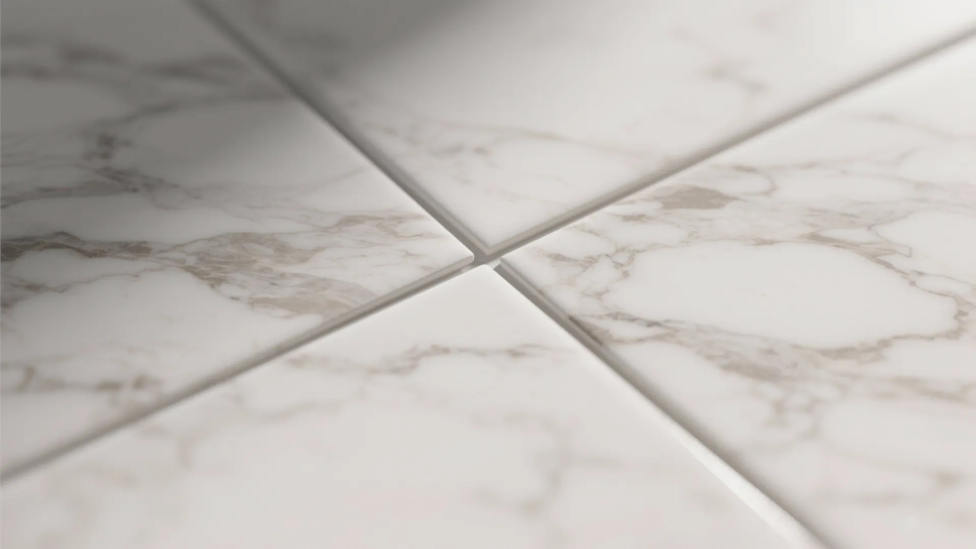 Close up view of white marble floor tiles with grey veins and clean white grout