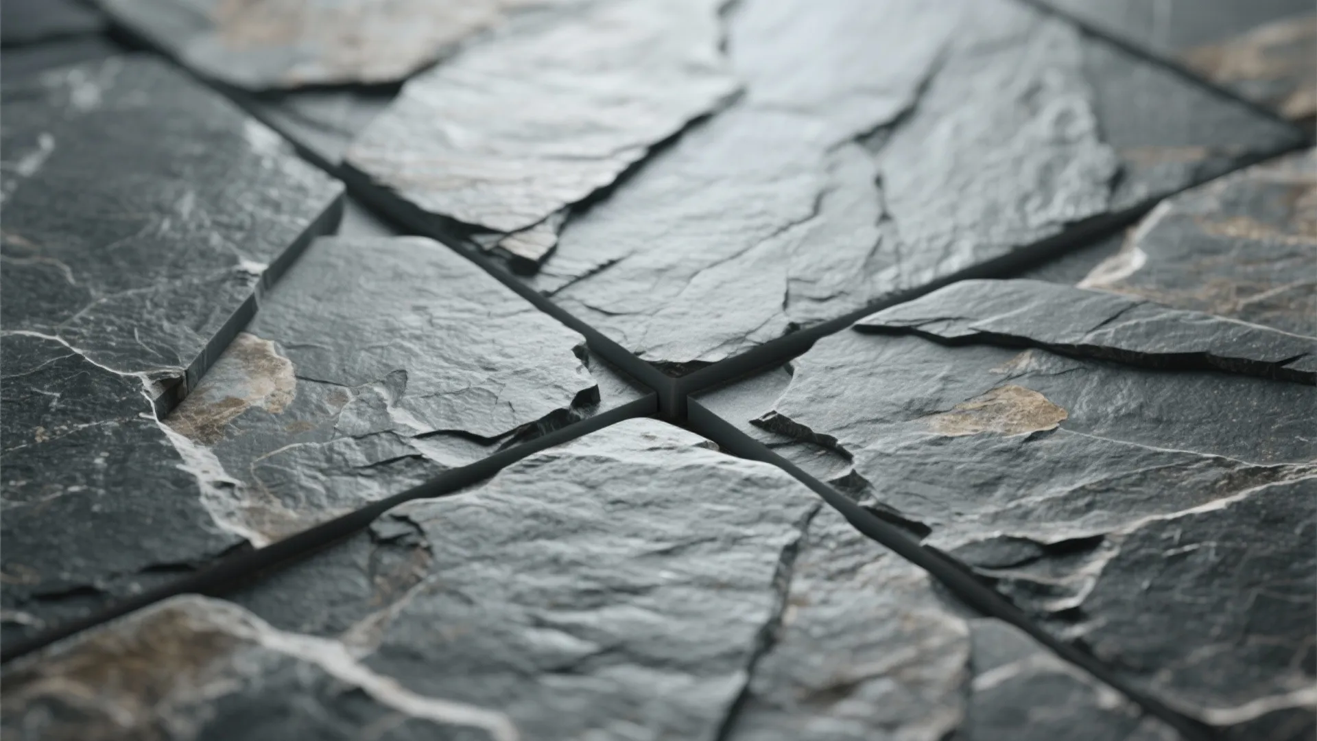 Macro view of textured stone-look porcelain with split-face relief catching soft daylight.