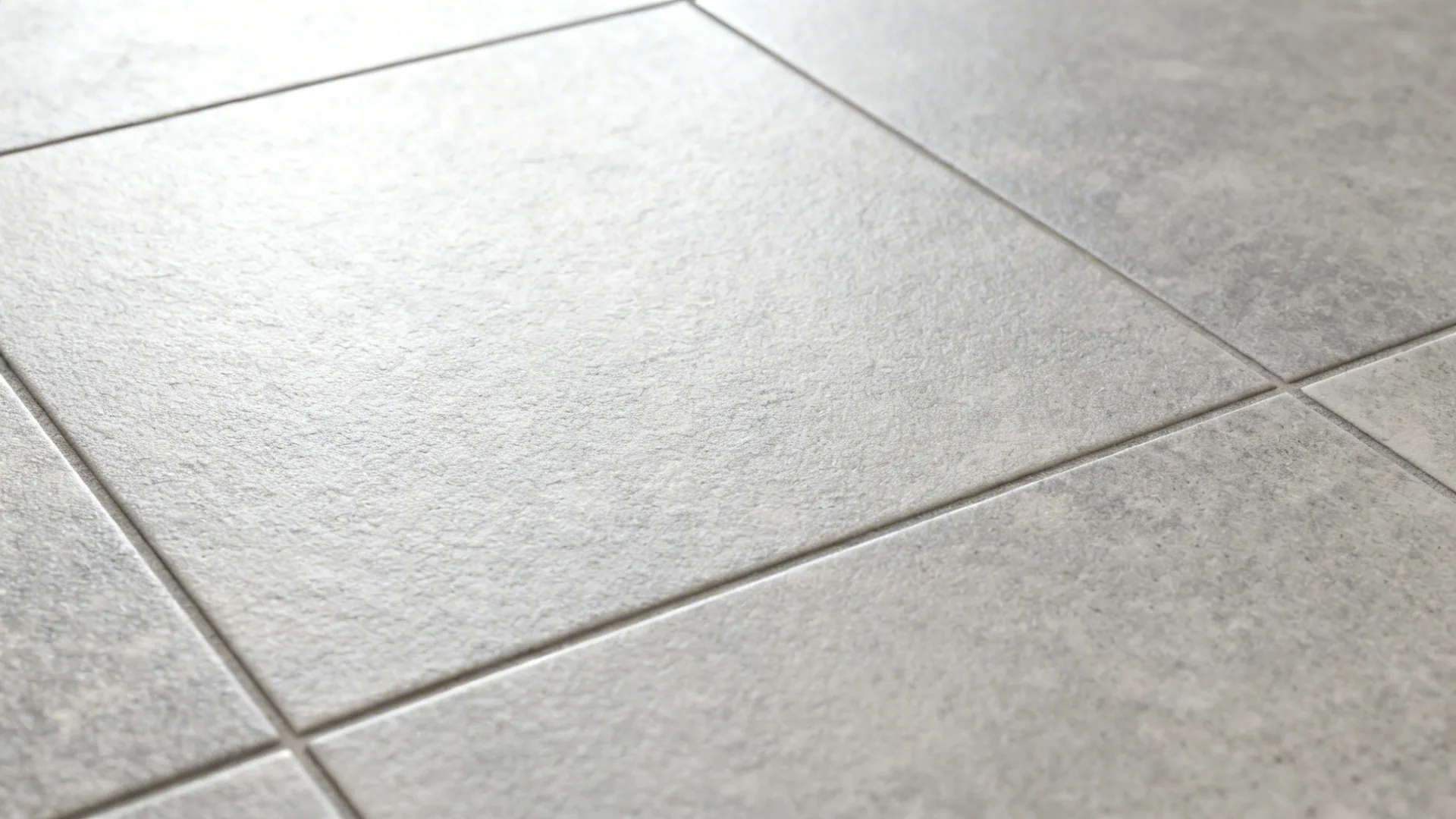 Macro top-down view of pearl gray porcelain with subtle micro-texture.