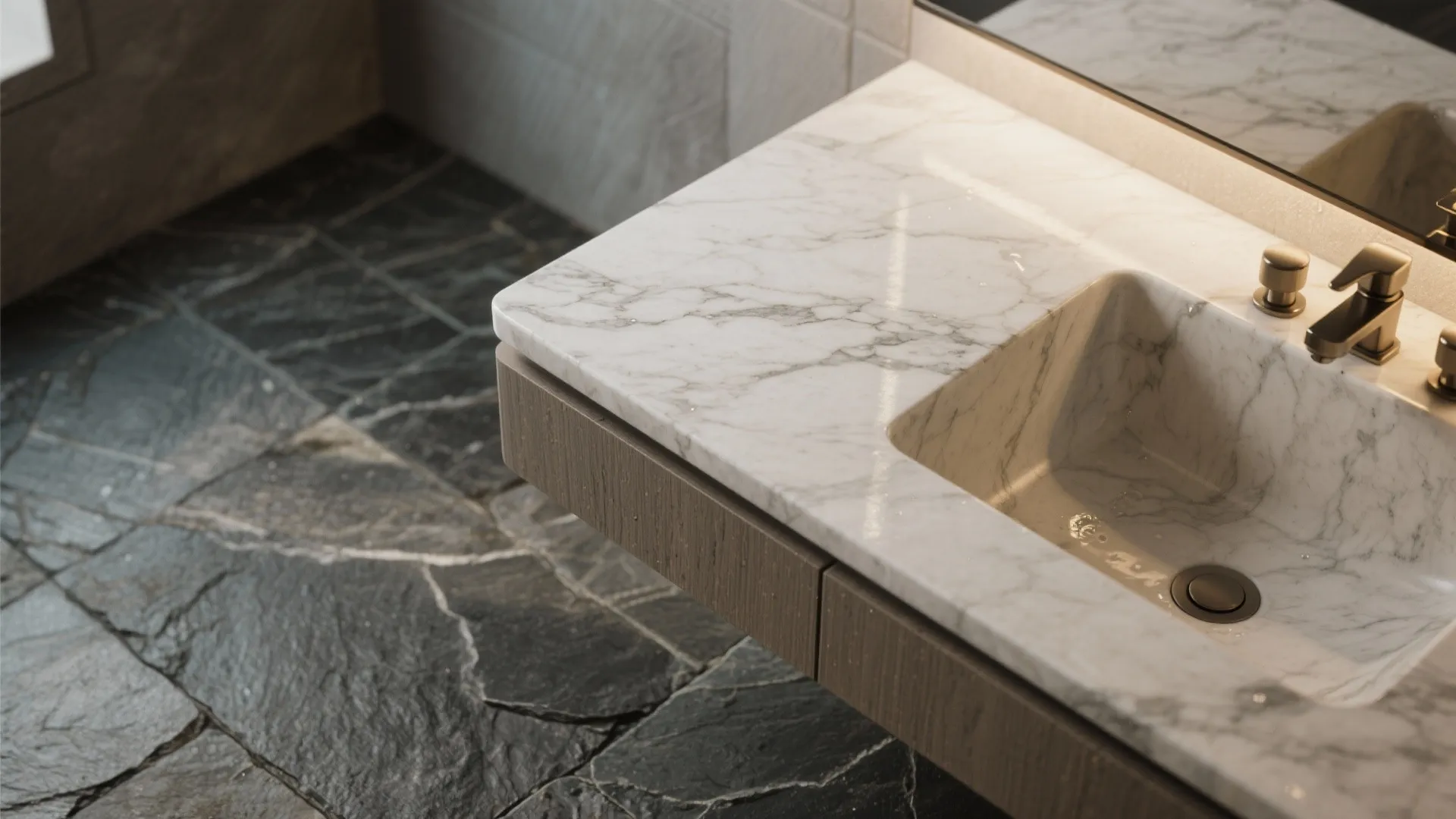 Close up of white marble sink with gold faucet on brown wood cabinet and stone floor